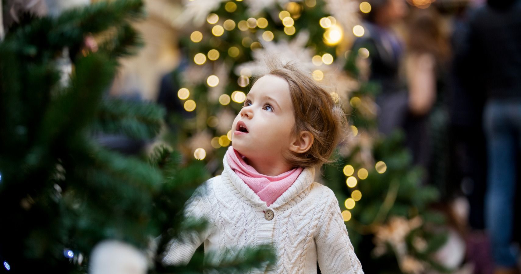 girl looking at christmas trees