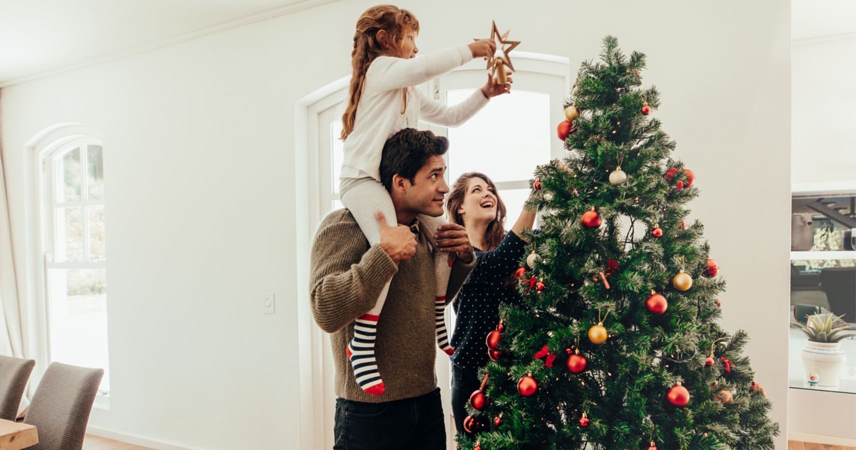 family decorating christmas tree