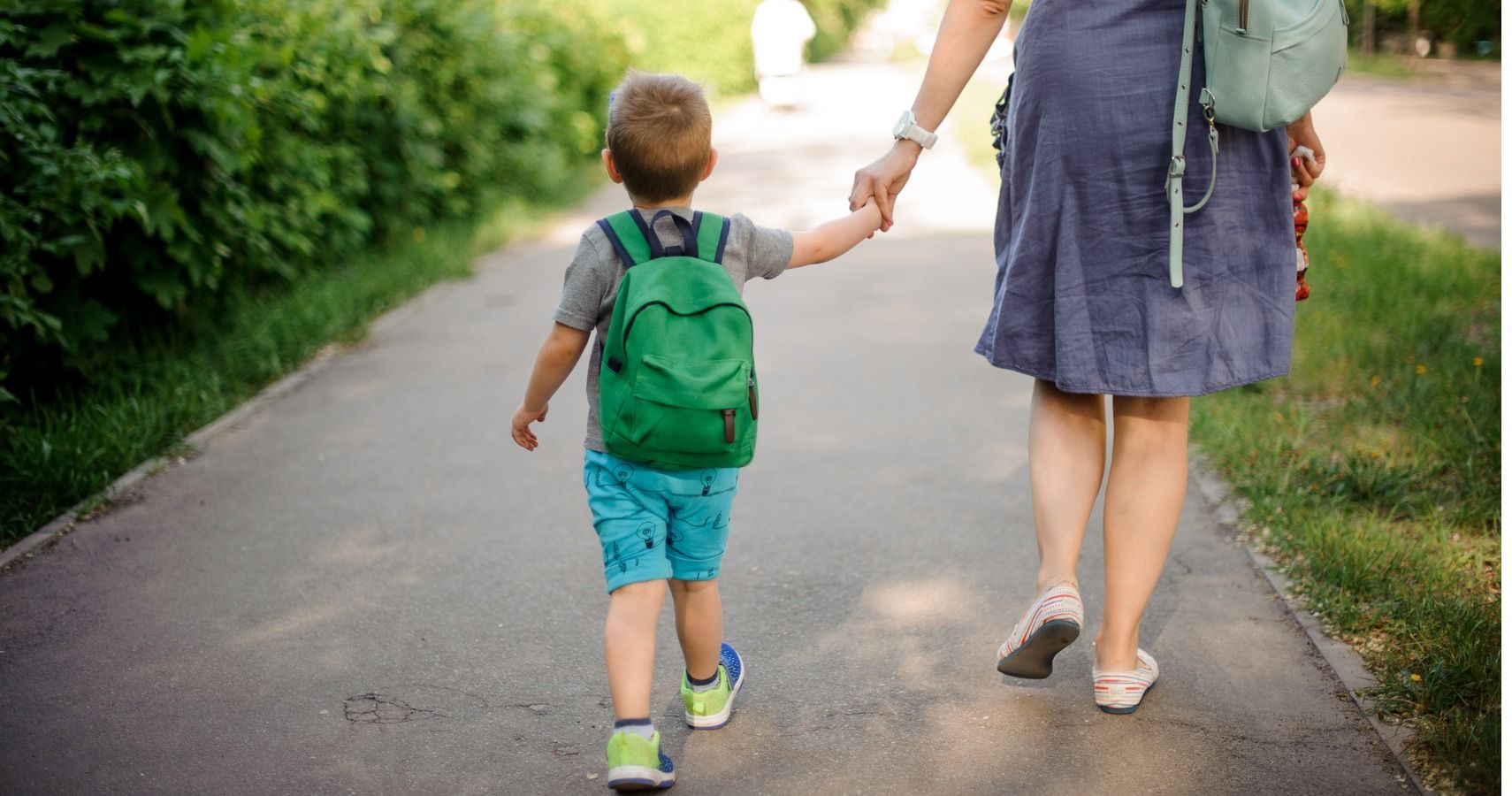 mom and son walking to school