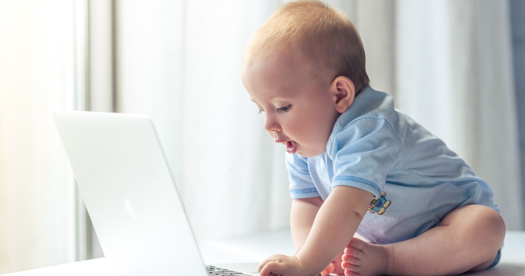baby playing on computer