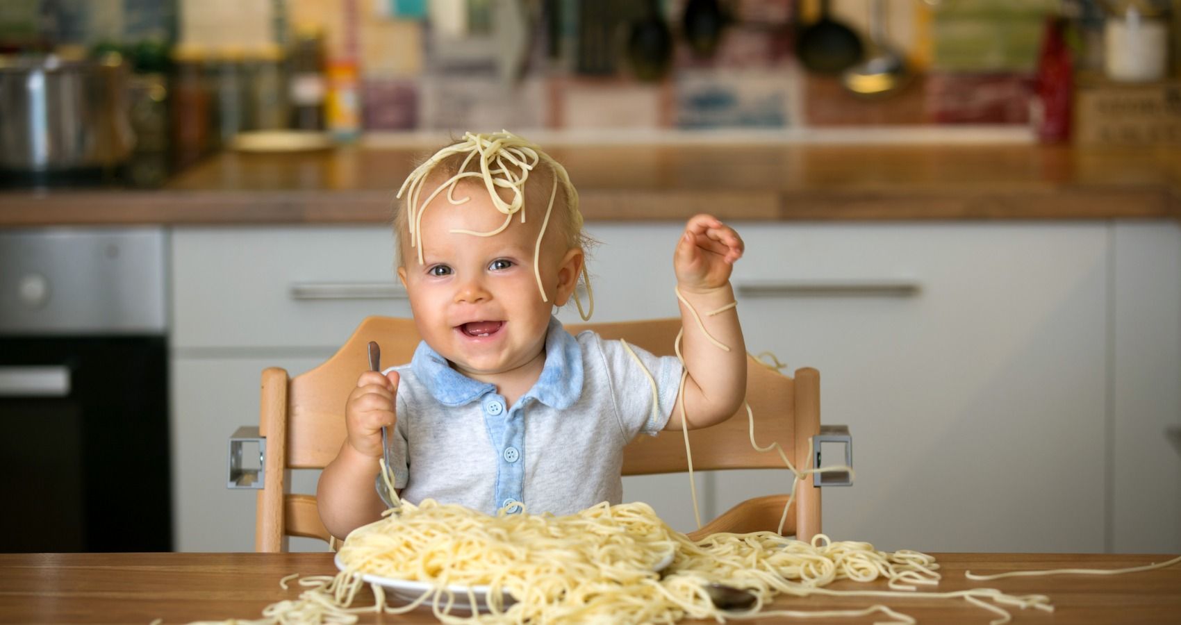 baby eating pasta