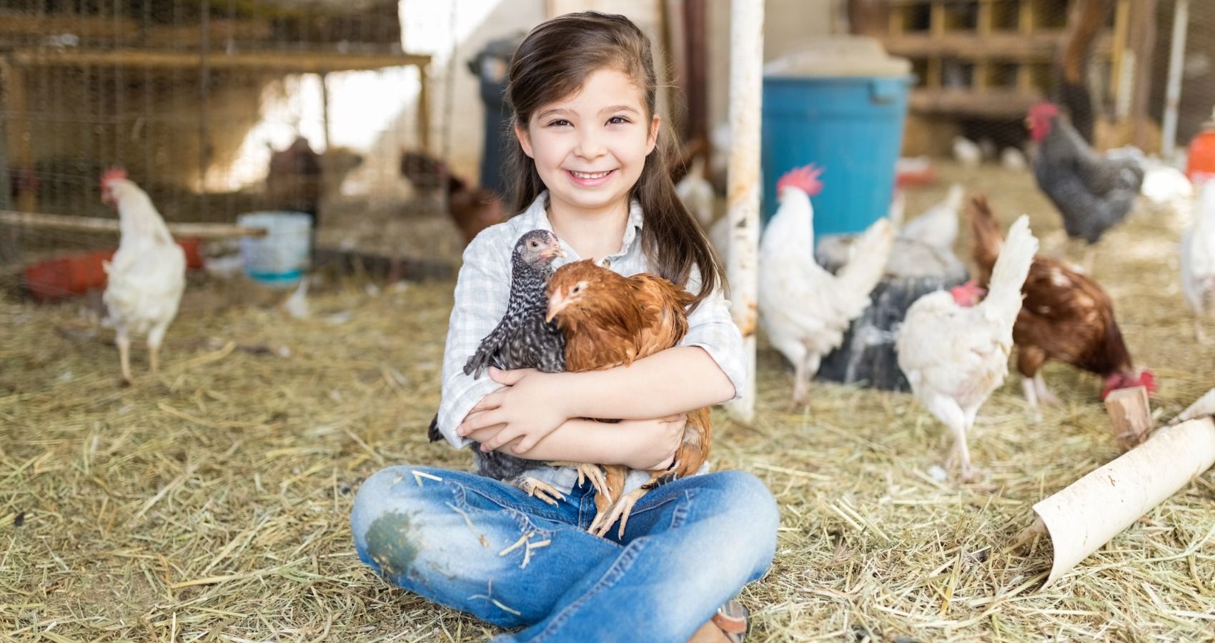 girl cuddling chicken