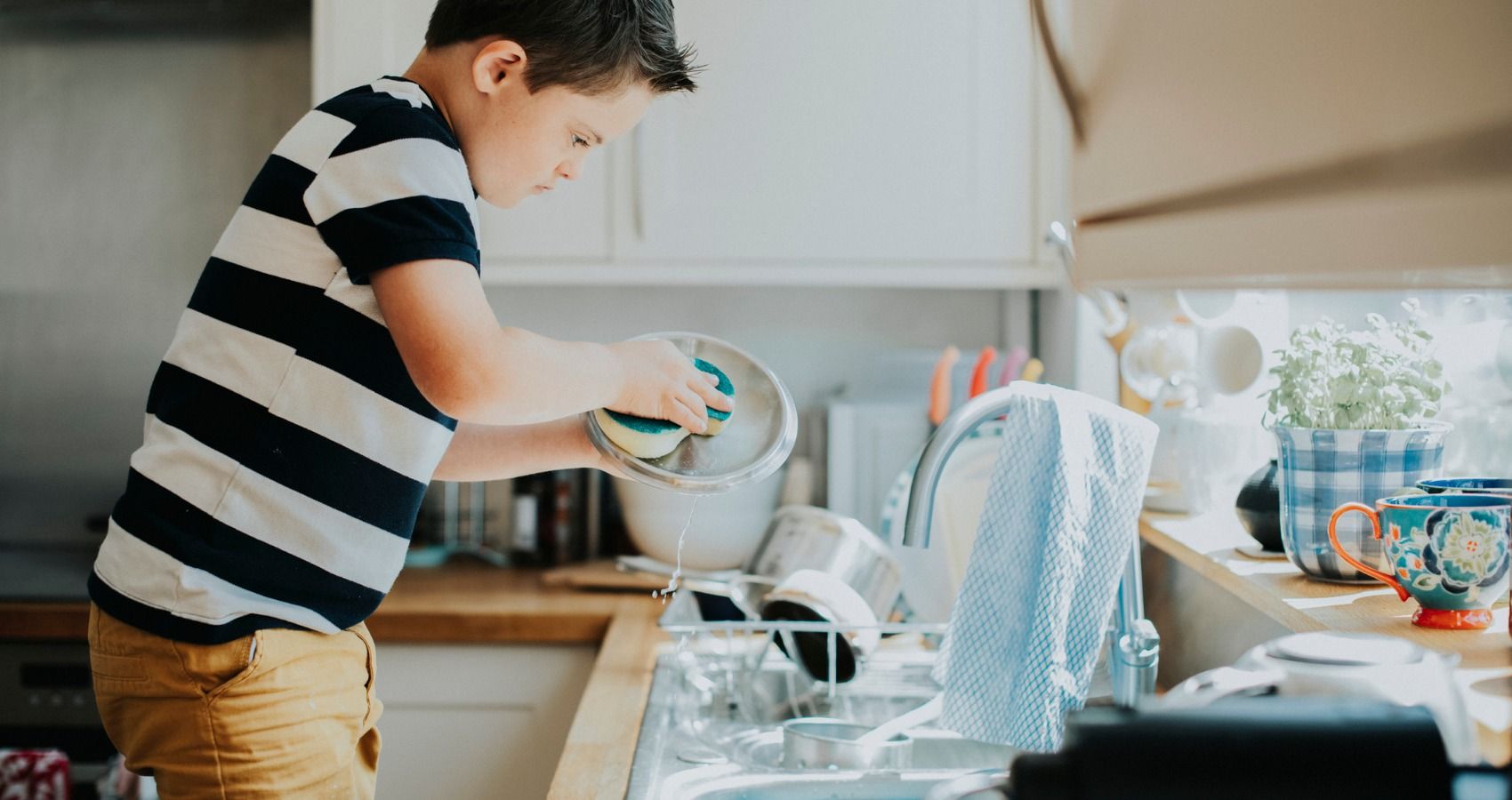boy doing dishes