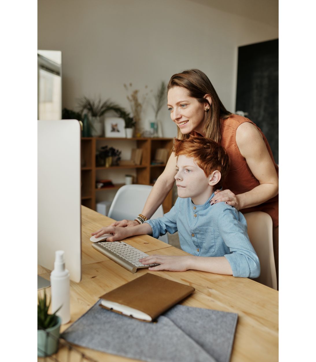 A mom and her son doing some online work