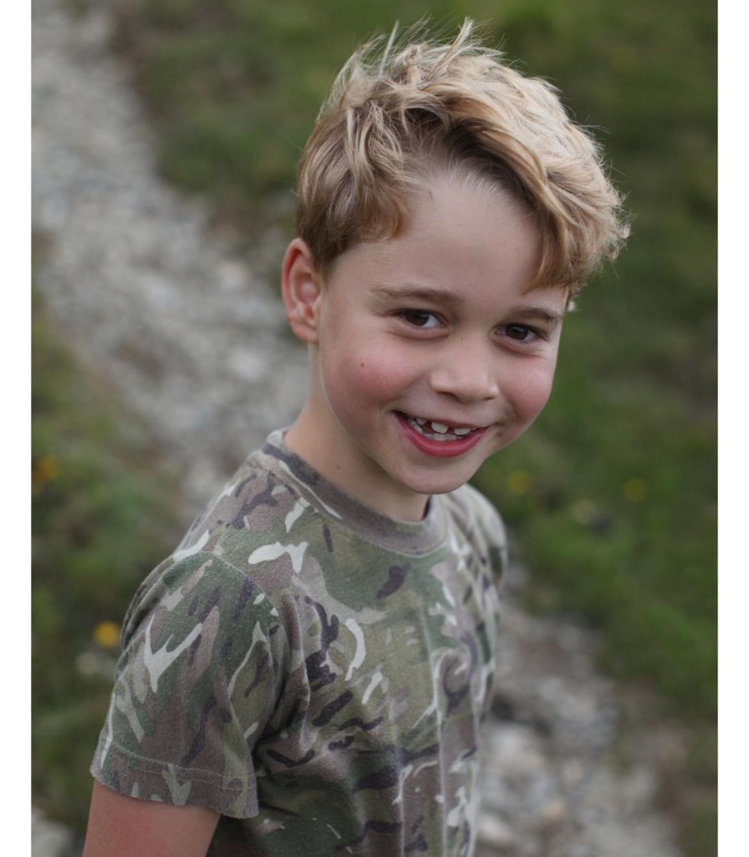A picture of Prince George wearing camo and smiling