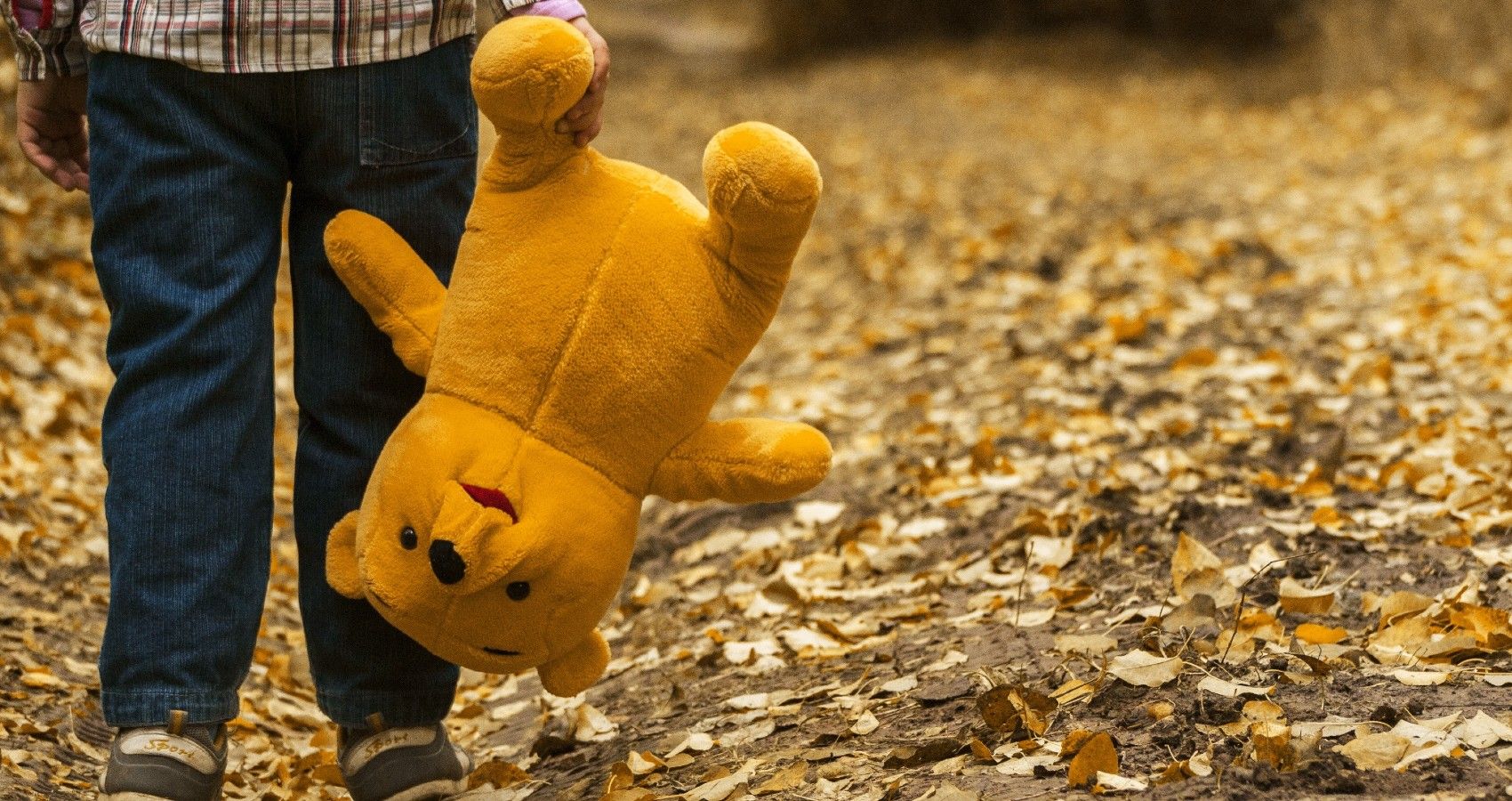 A boy holding on to a teddy bear
