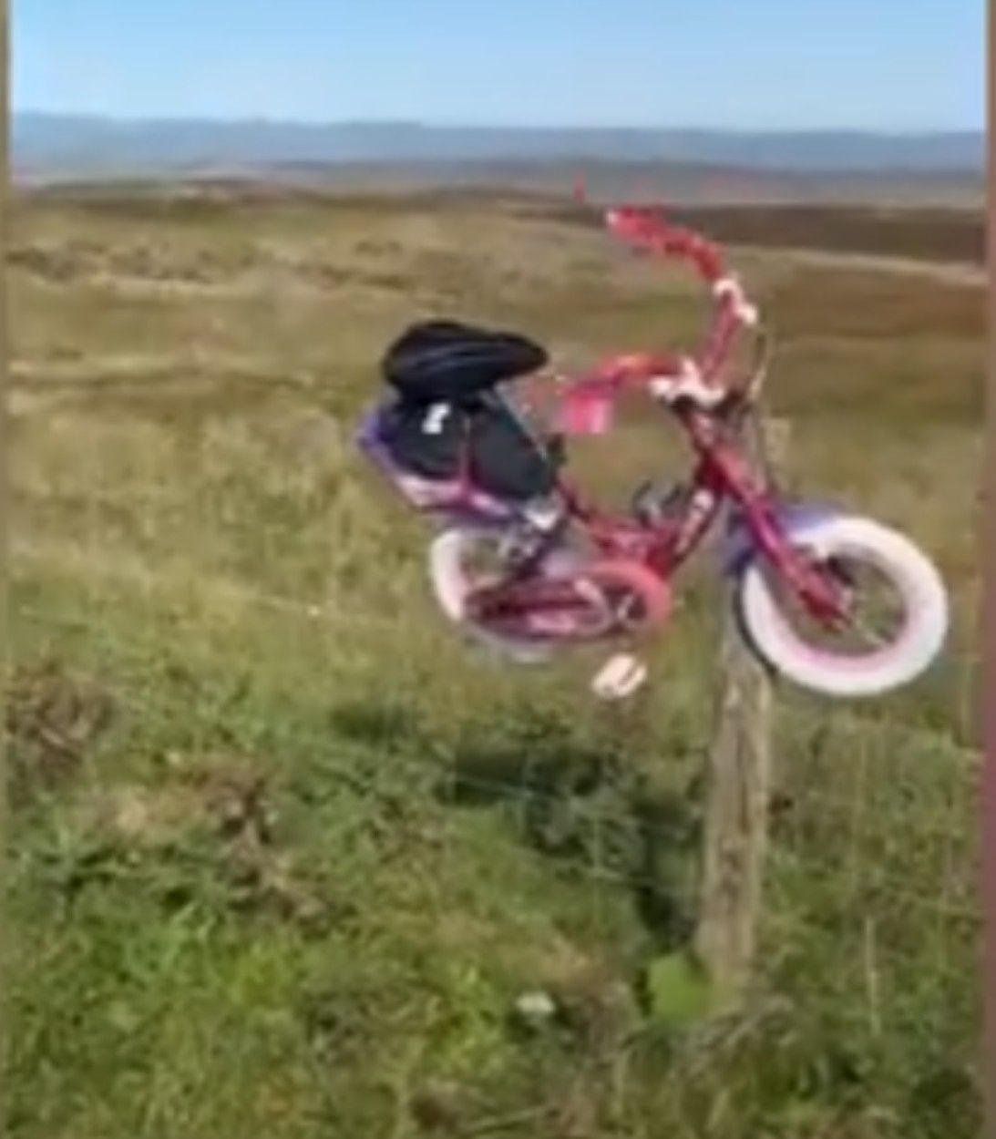 Screenshot of YouTube video showing a dad who rode 200 miles for charity on pink bike