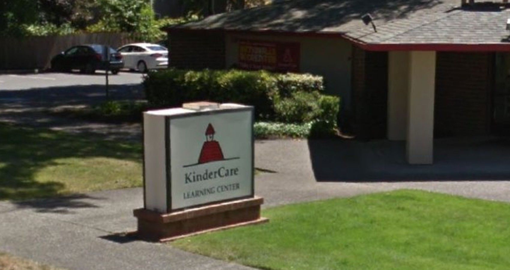 A sign for Kindercare on lawn