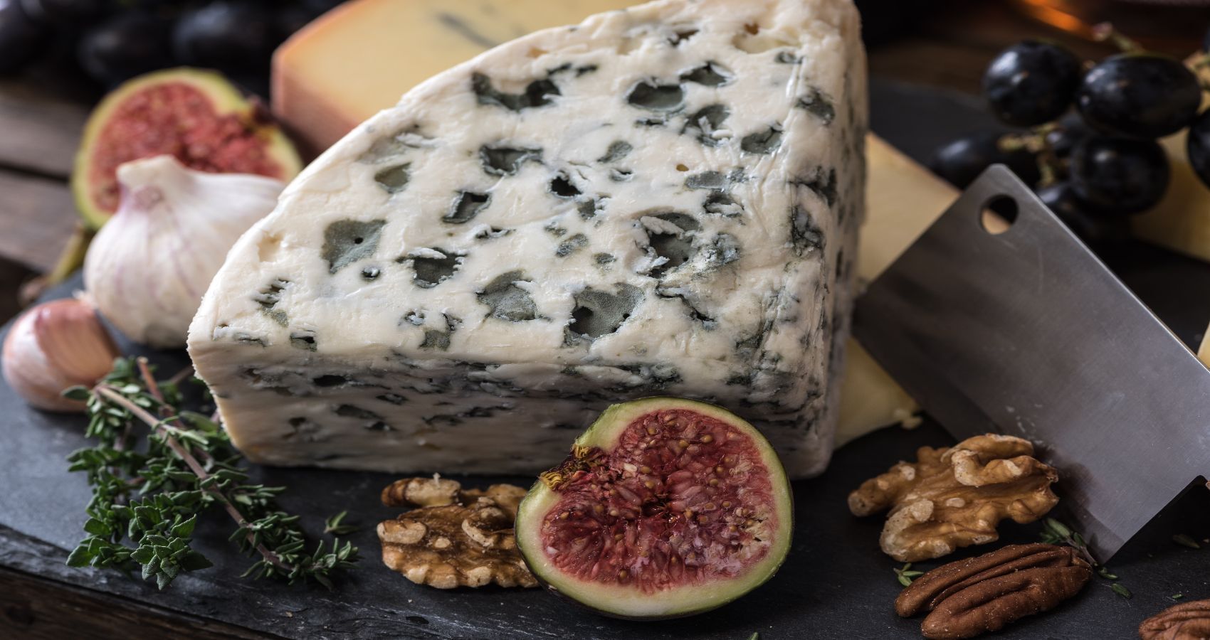A large block of blue cheese on a board