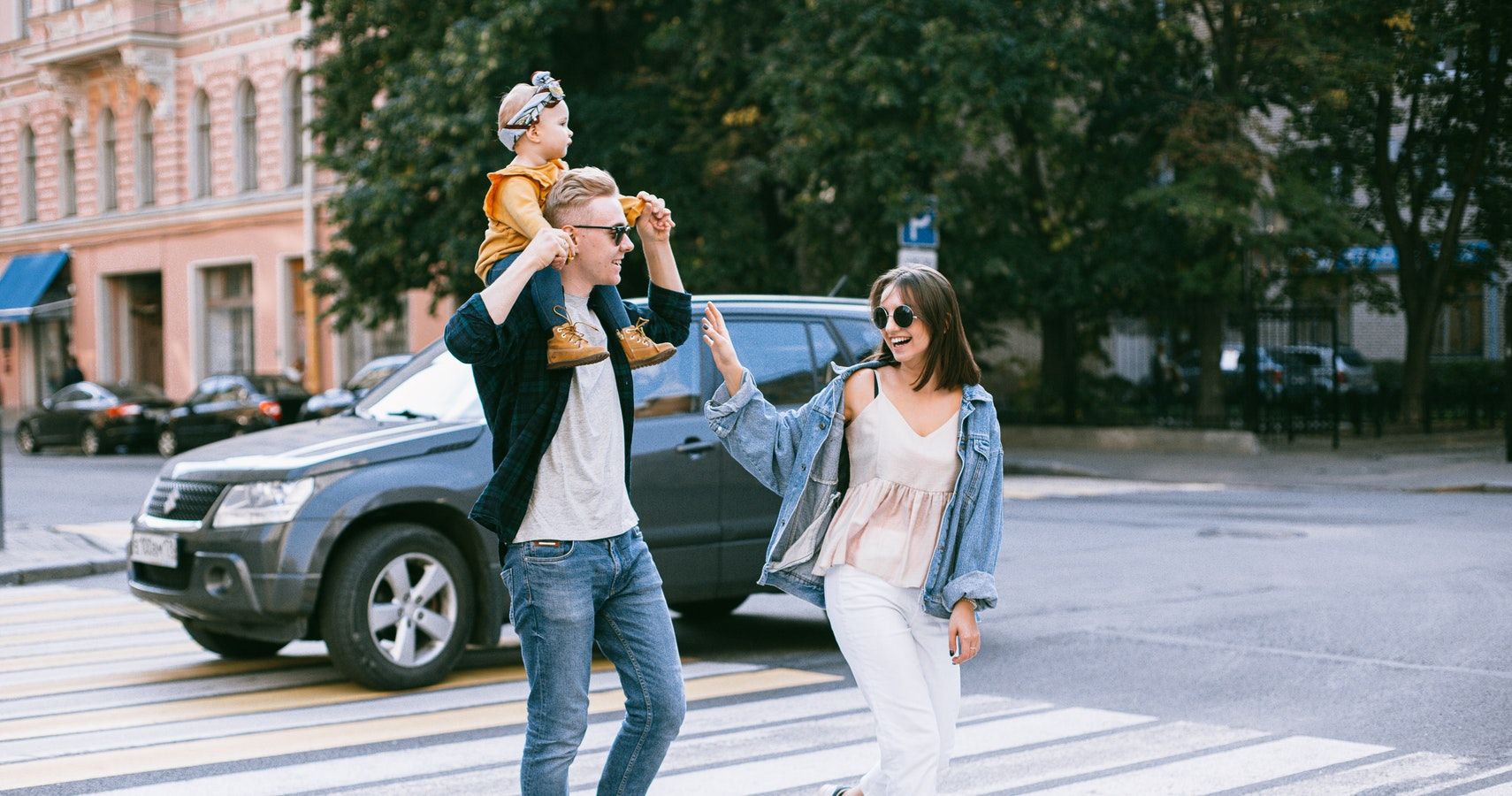 A Happy Family Crossing A Road
