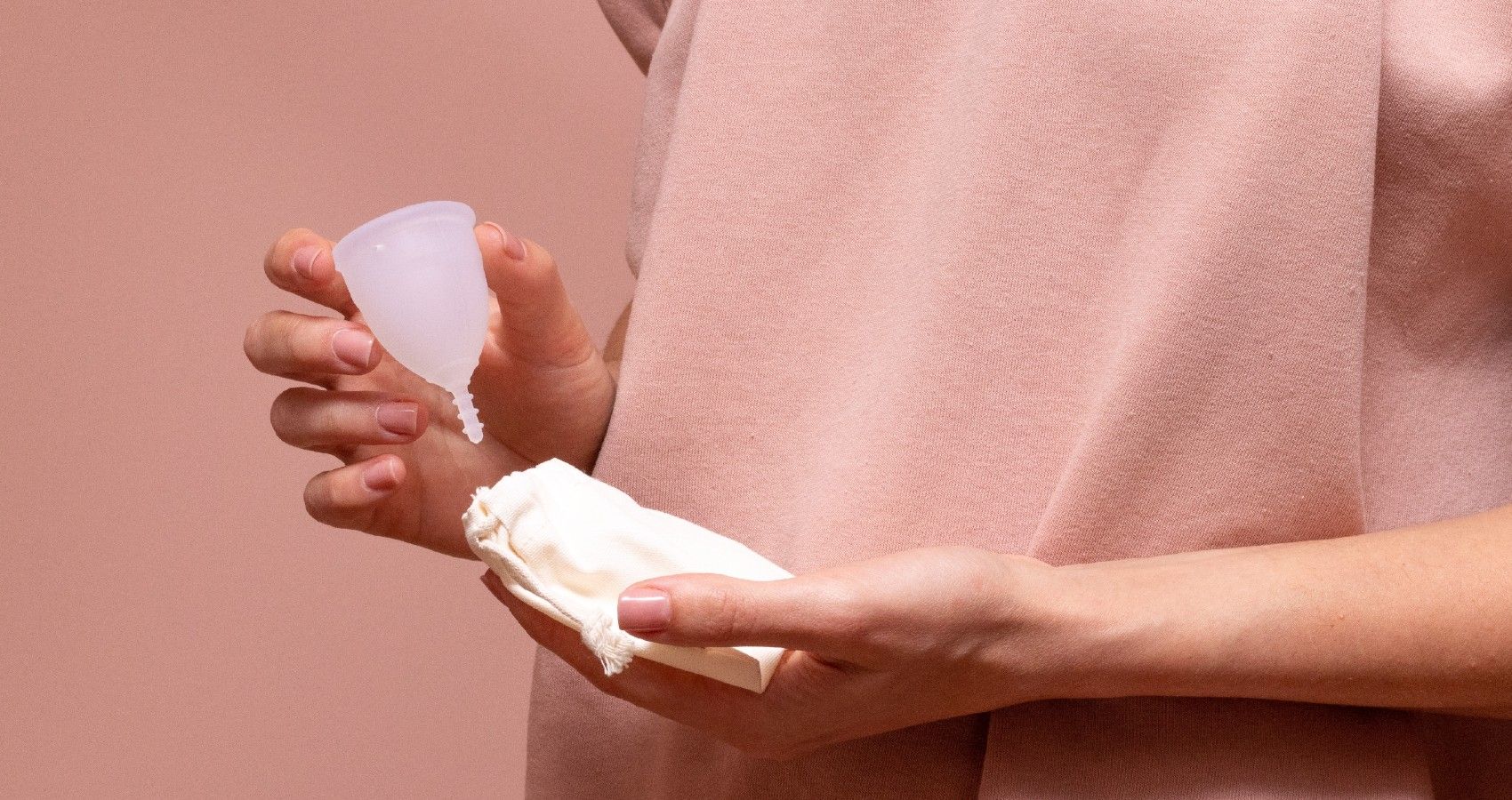 A woman holding feminine hygiene products in her hand