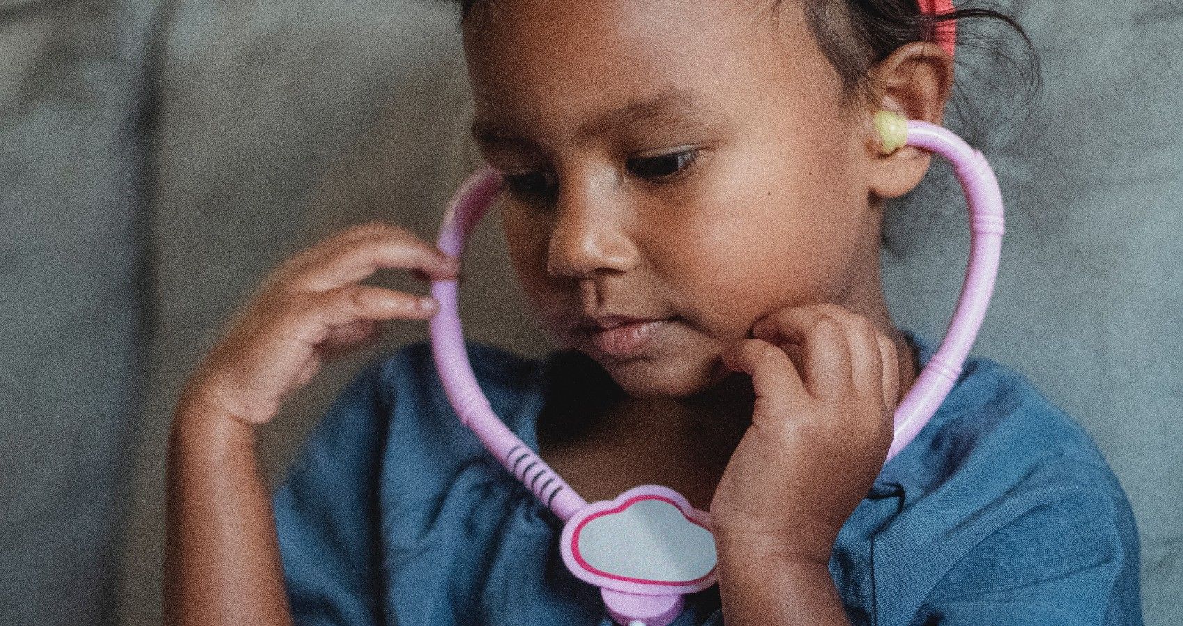 A child with a toy stethoscope