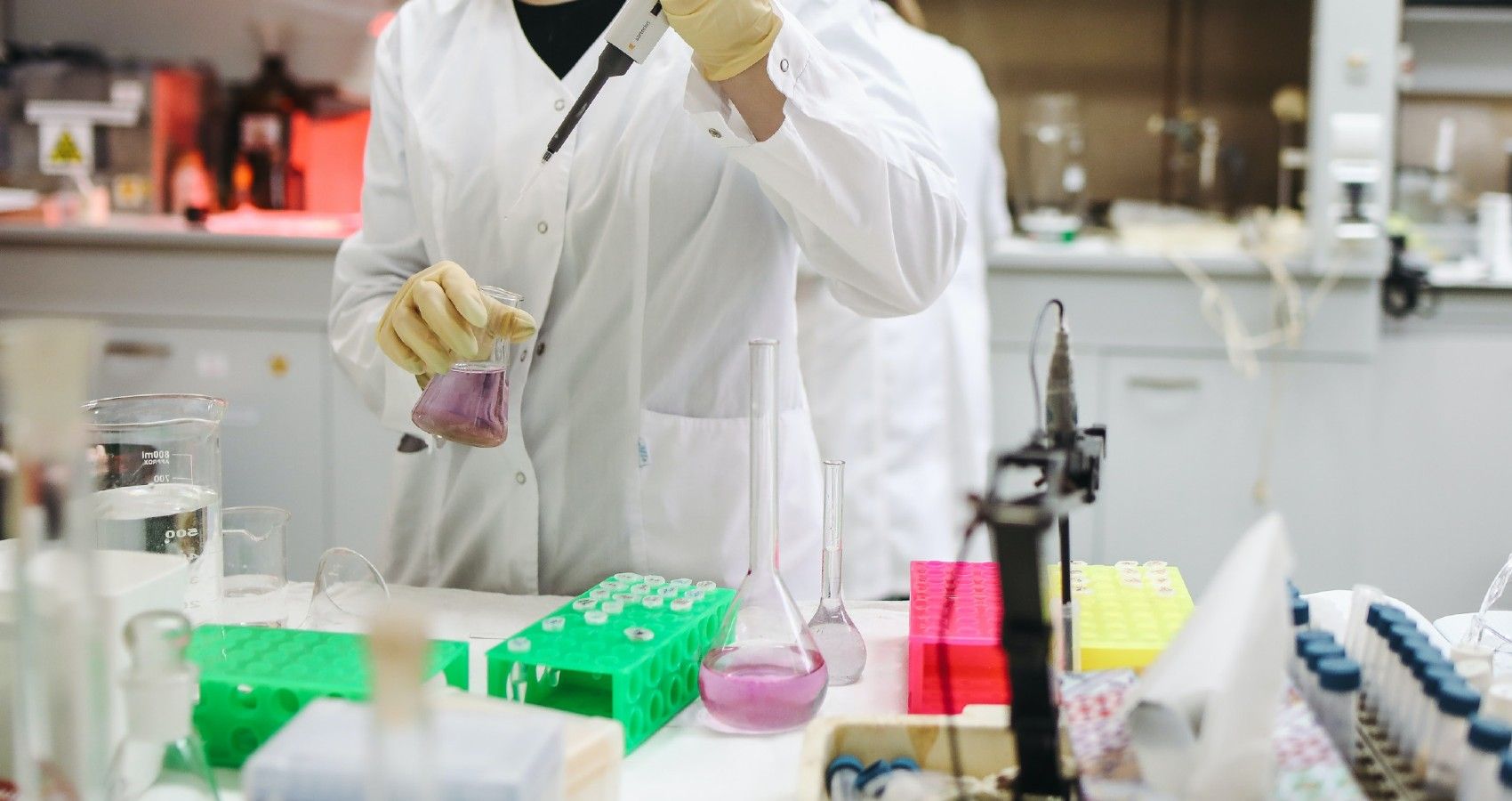 A scientist working in a lab on a vaccine