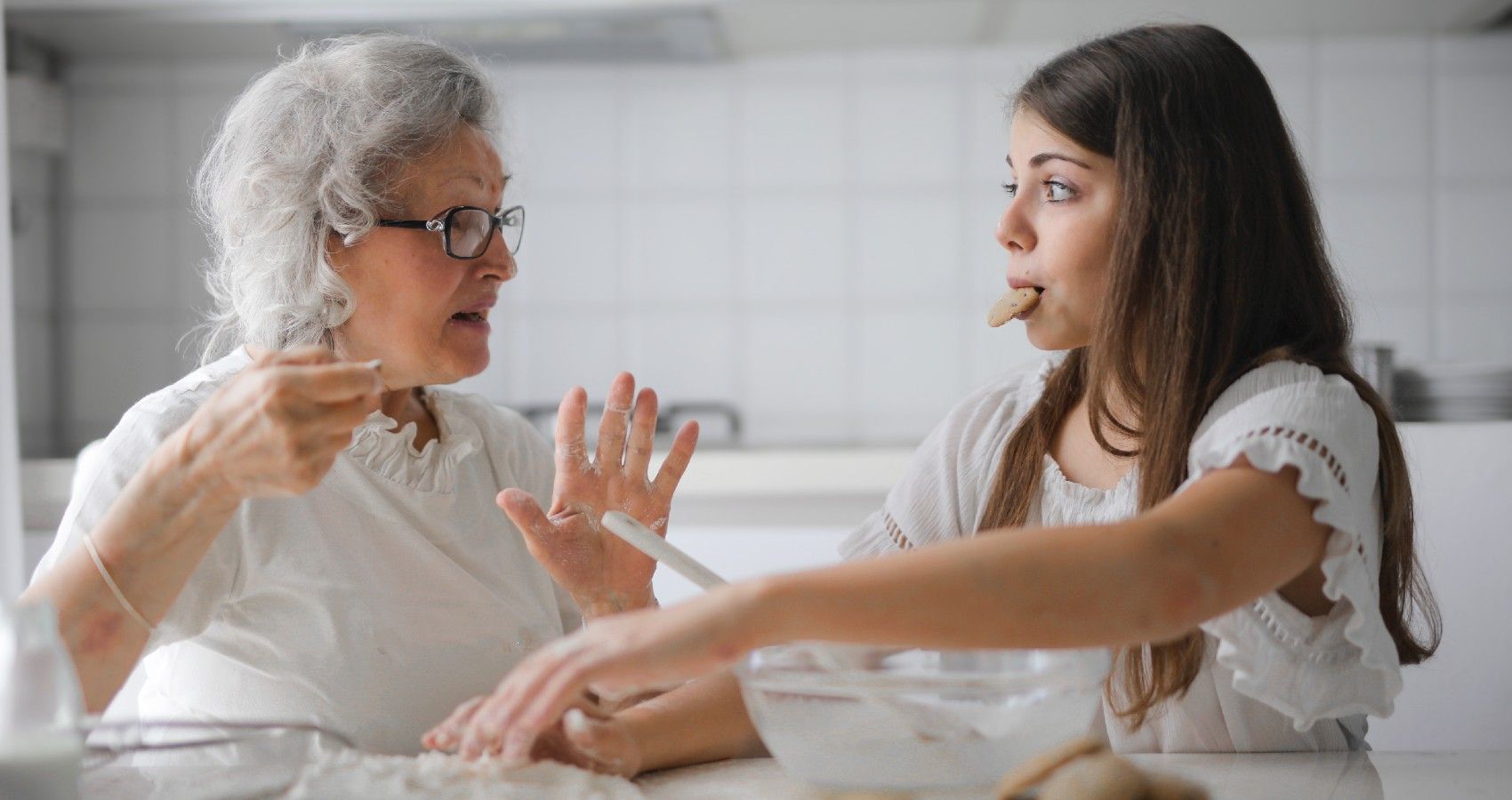 A granddaughter talking to her grandmother in the kitchen