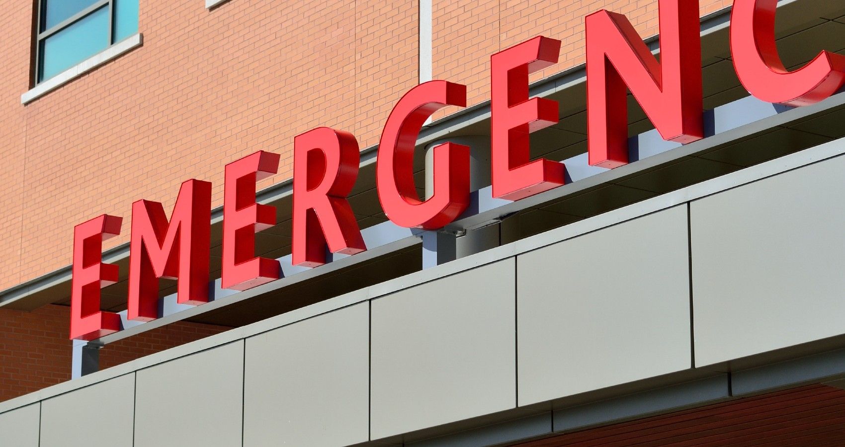 The outside of a hospital emergency room with red letters