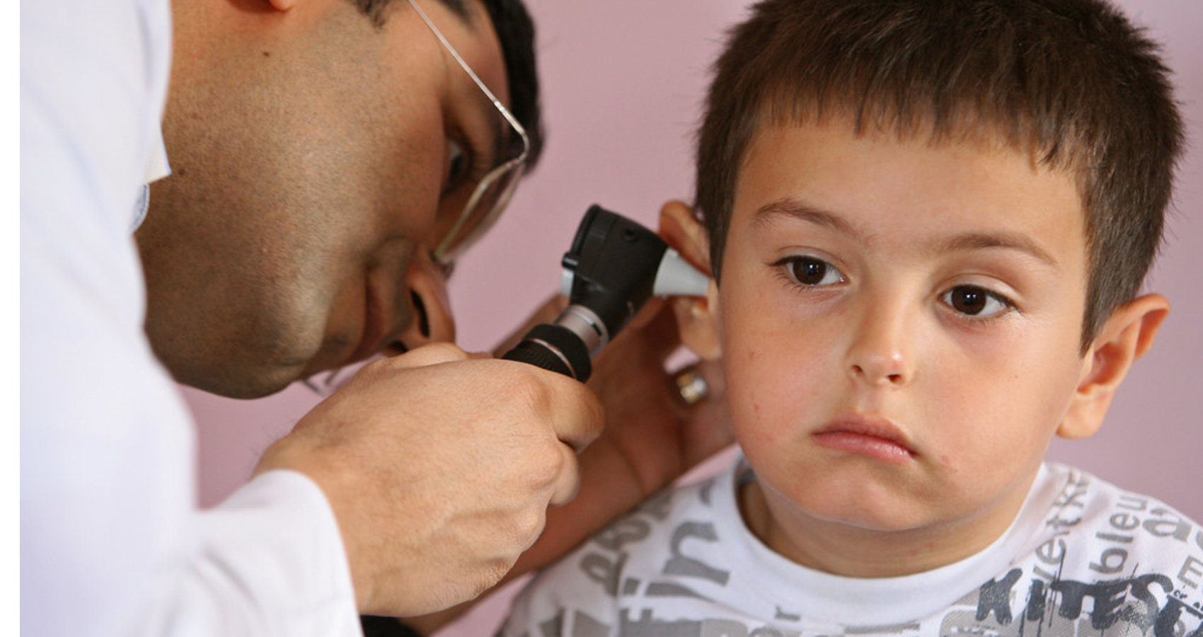 A child getting their ear checked at doctor