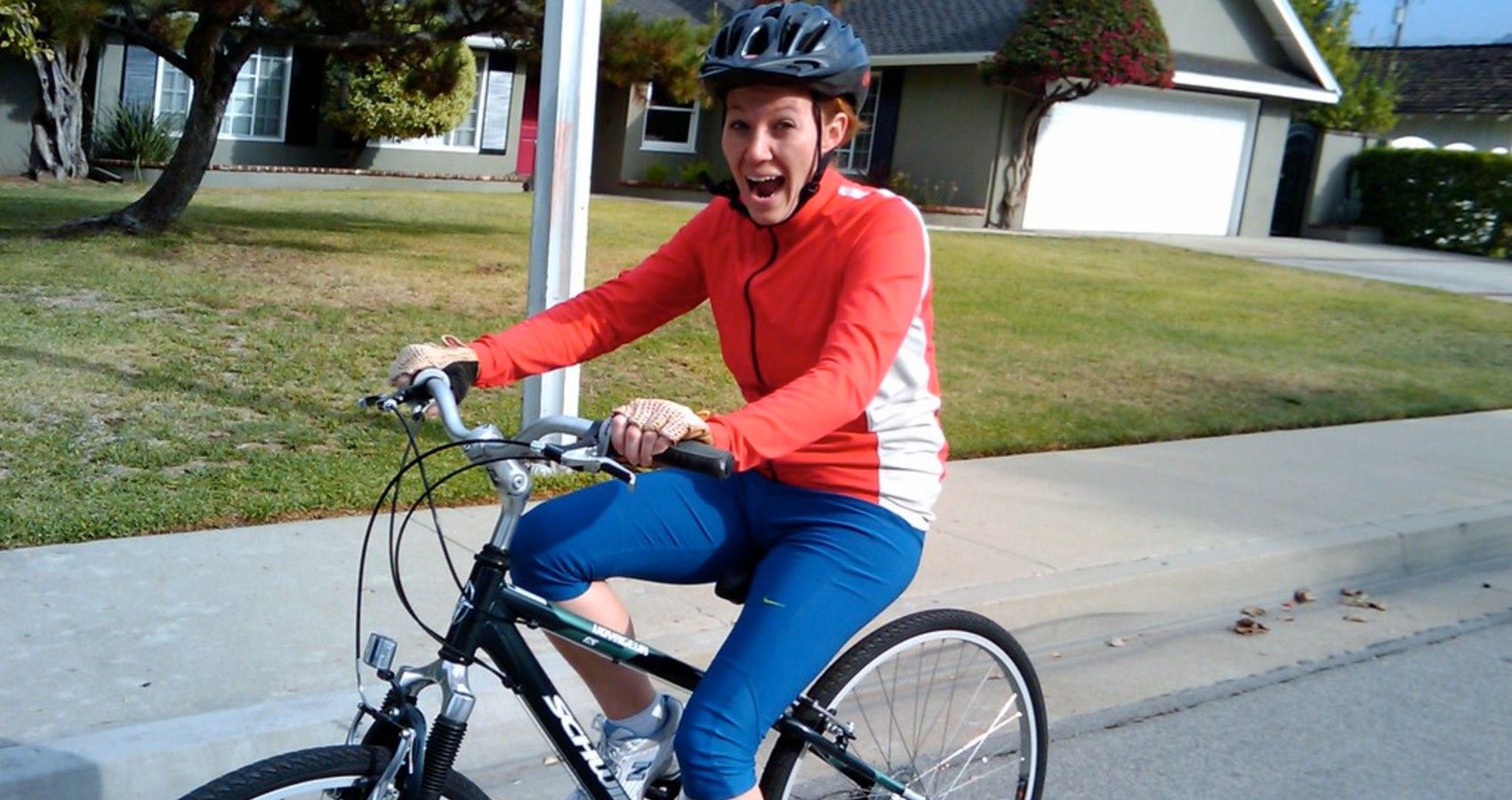 A woman riding a bike with a helmet on