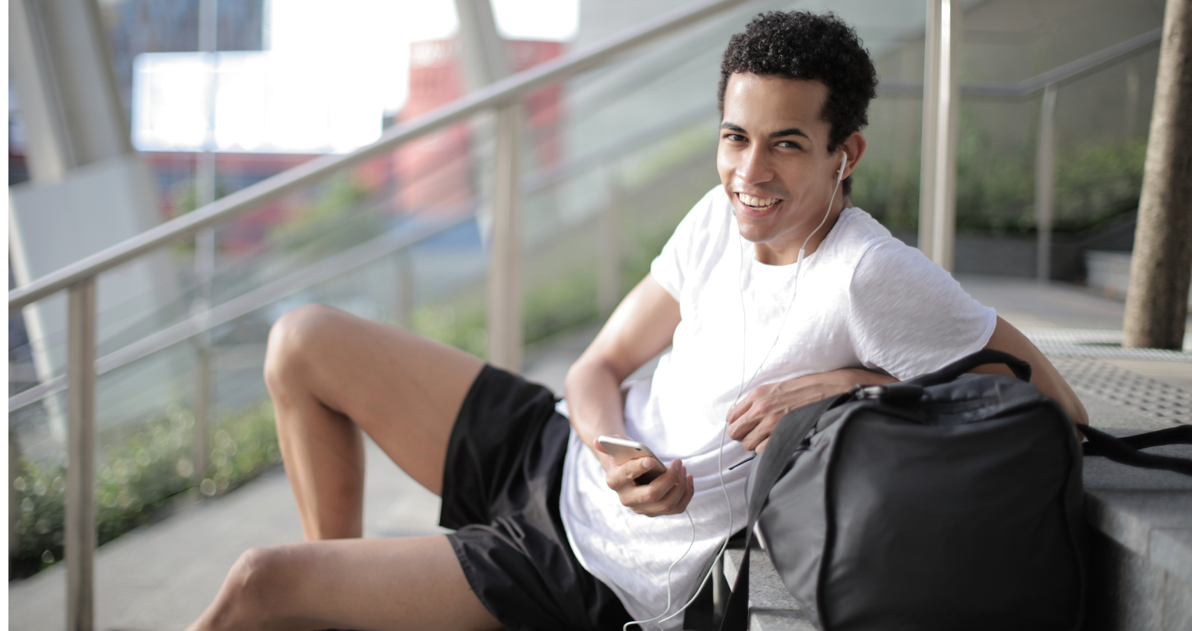 A man sitting there and wearing shorts