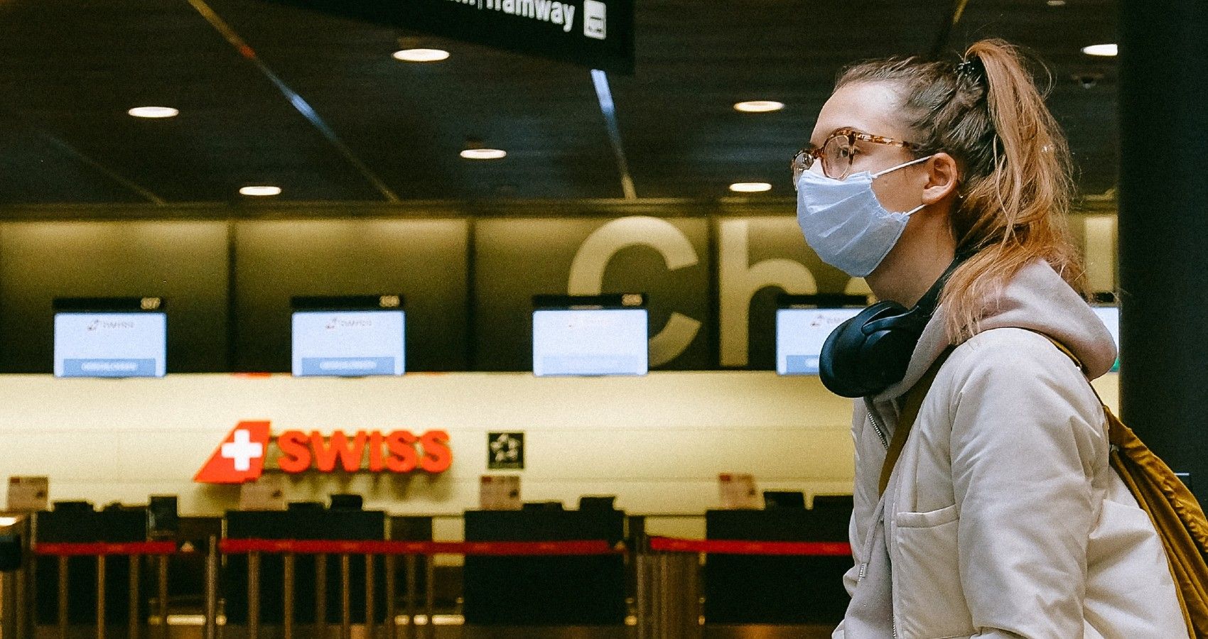 A woman at the airport with a face mask on