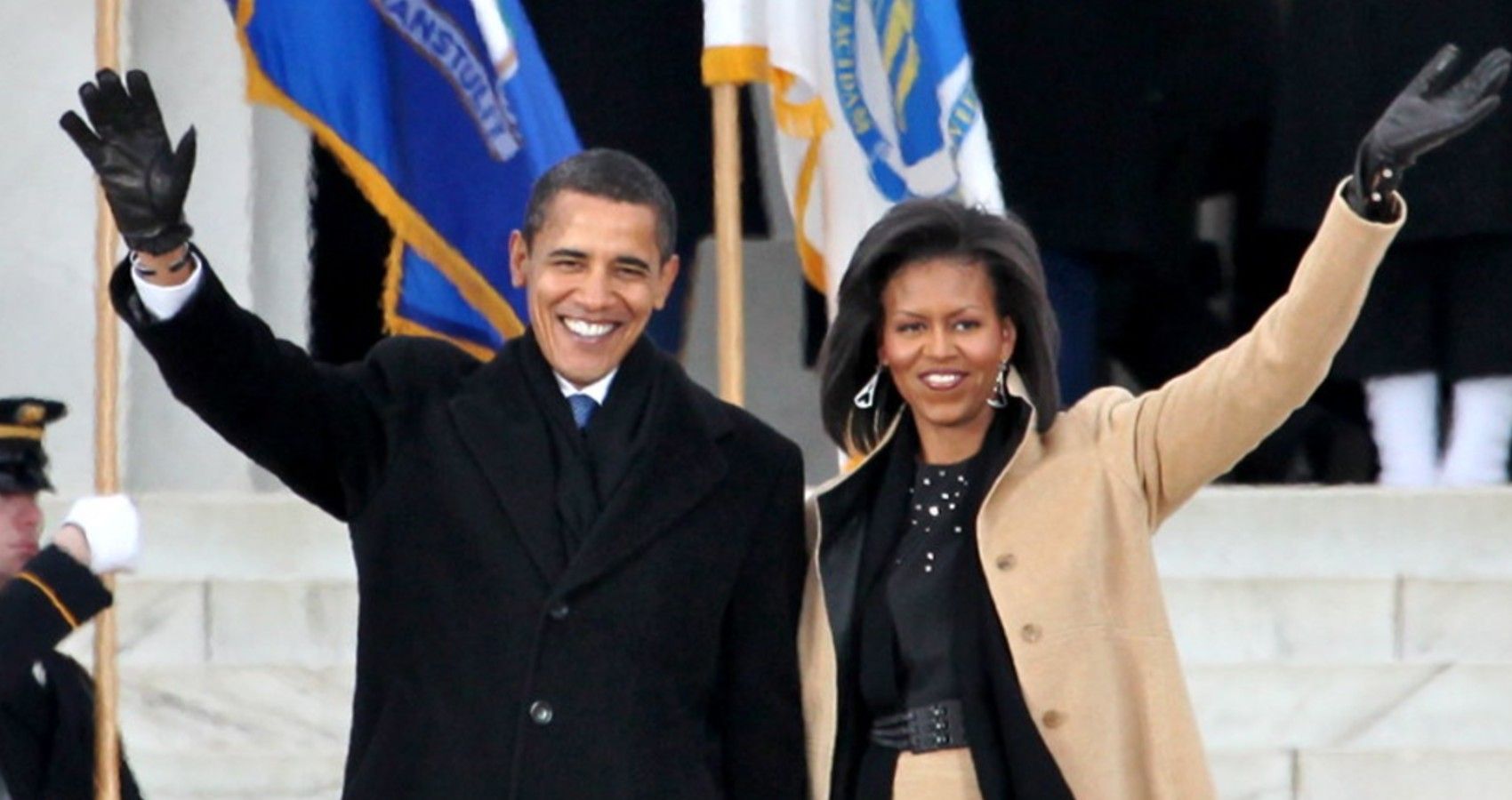 Barack and Michelle Obama waving at the crowd