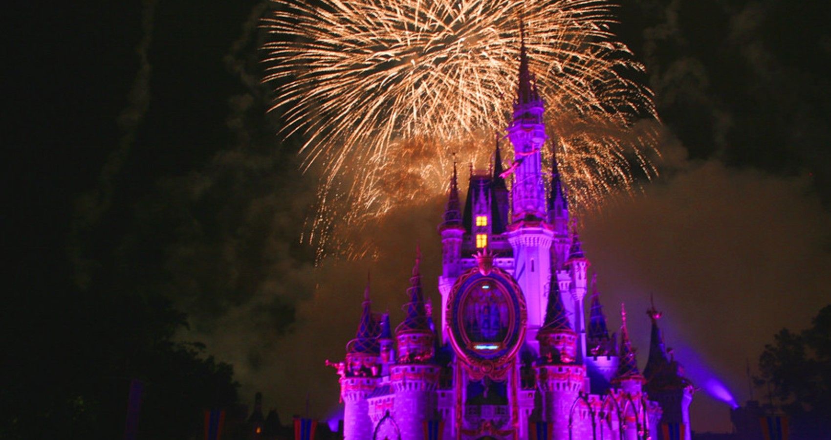 Disney world caste at night with fireworks
