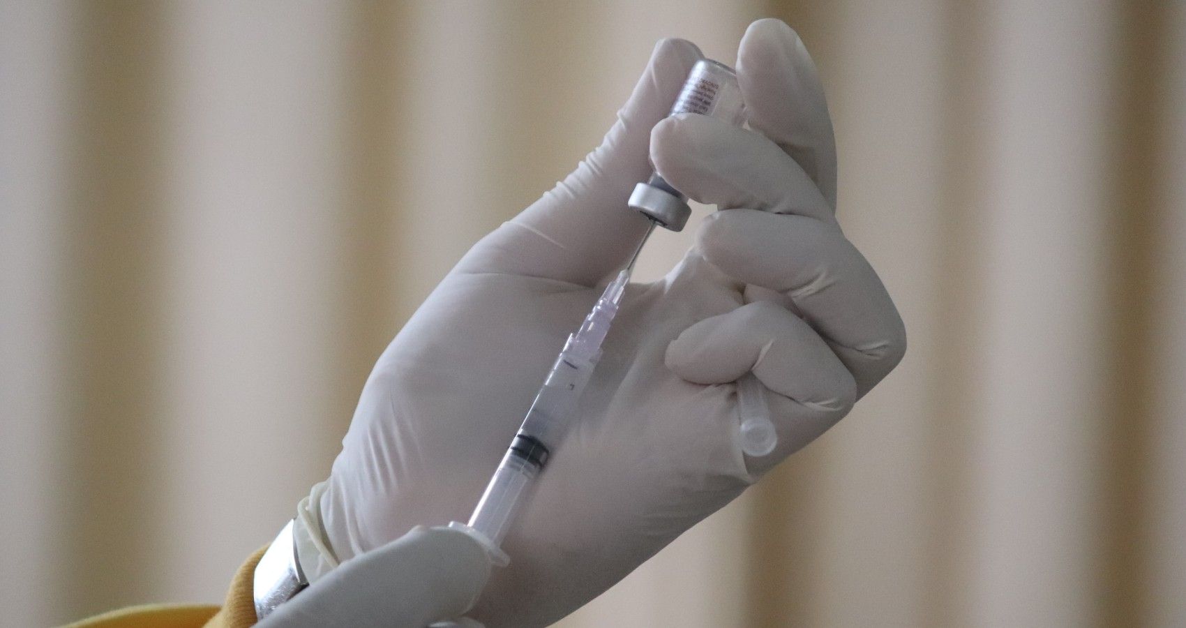 A Person Filling Up A Vaccine Syringe
