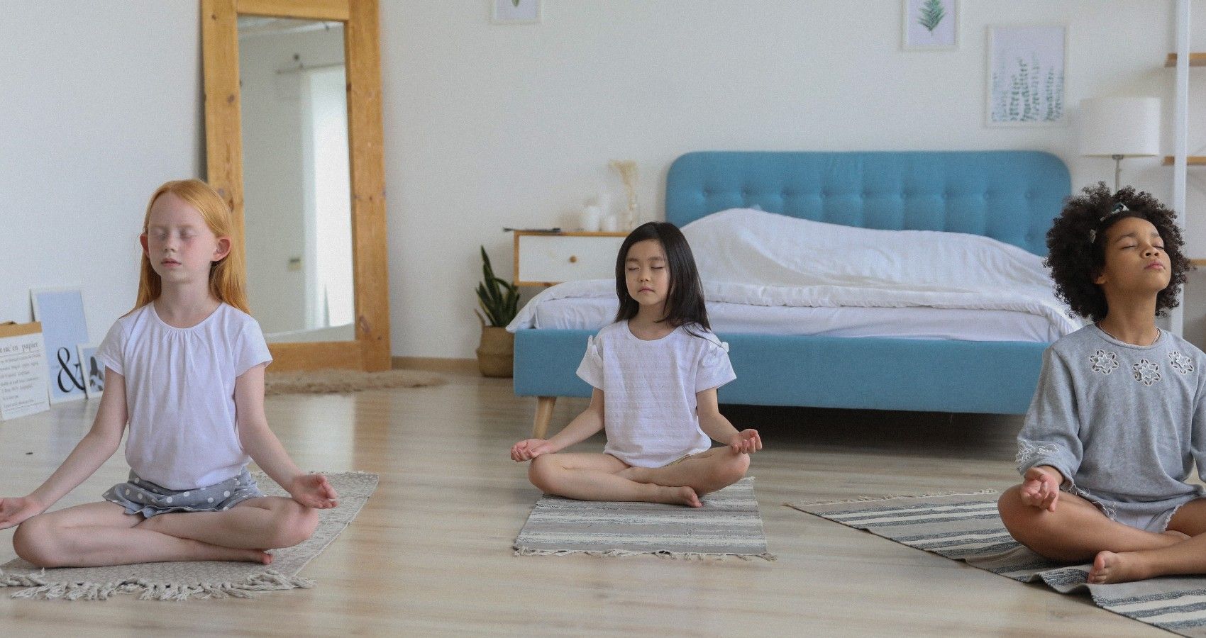 Three Children Sitting In A Room And Meditating