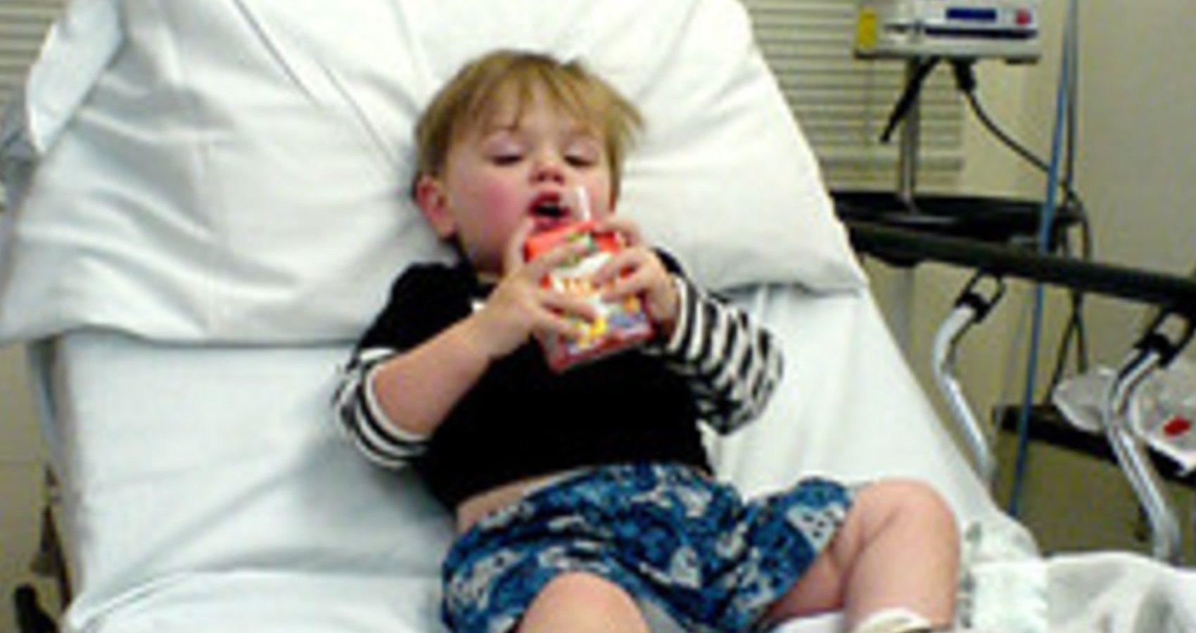 A Child Drinking Juice In The Hospital