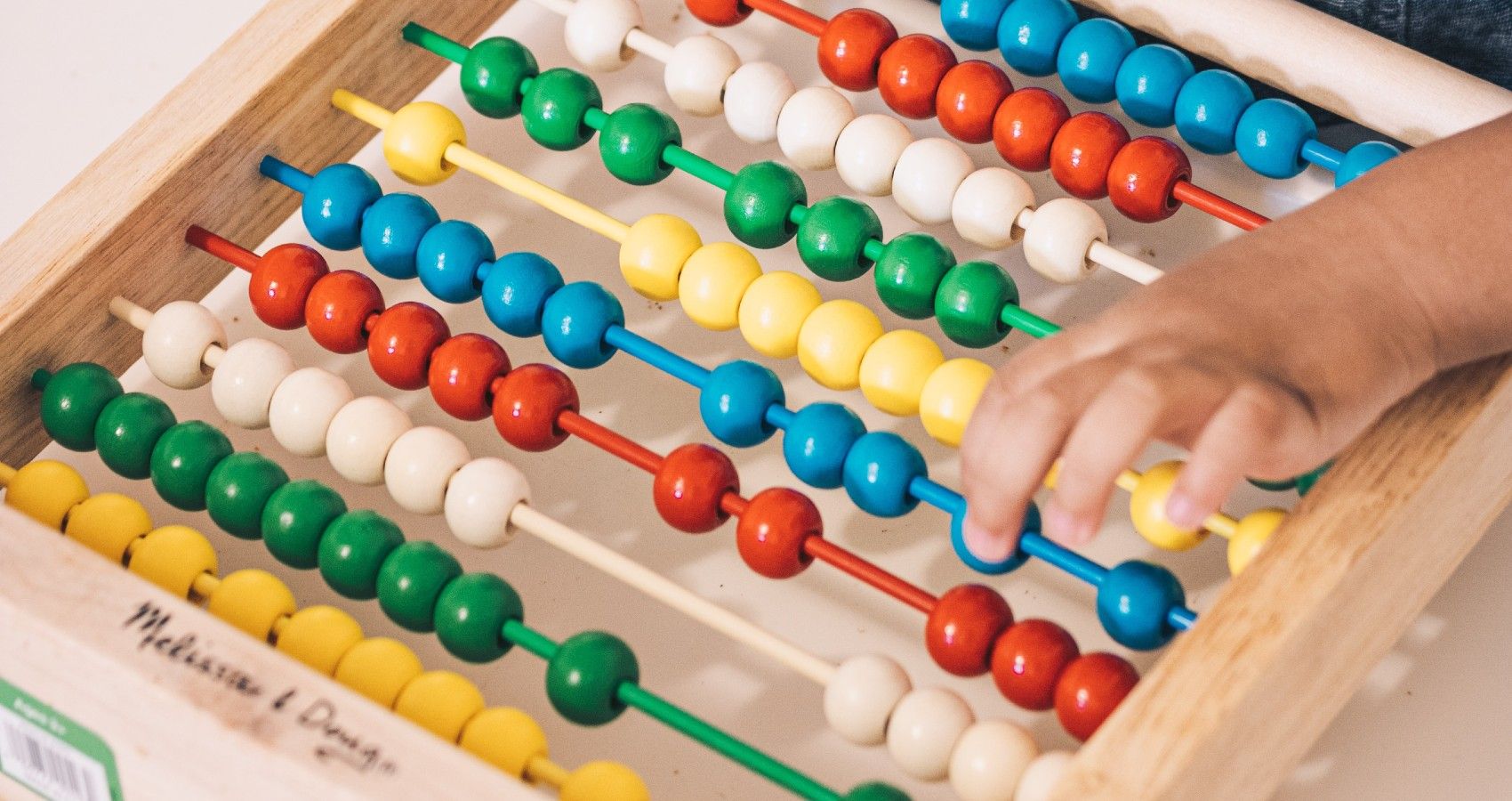 A Child Playing With An Abacus