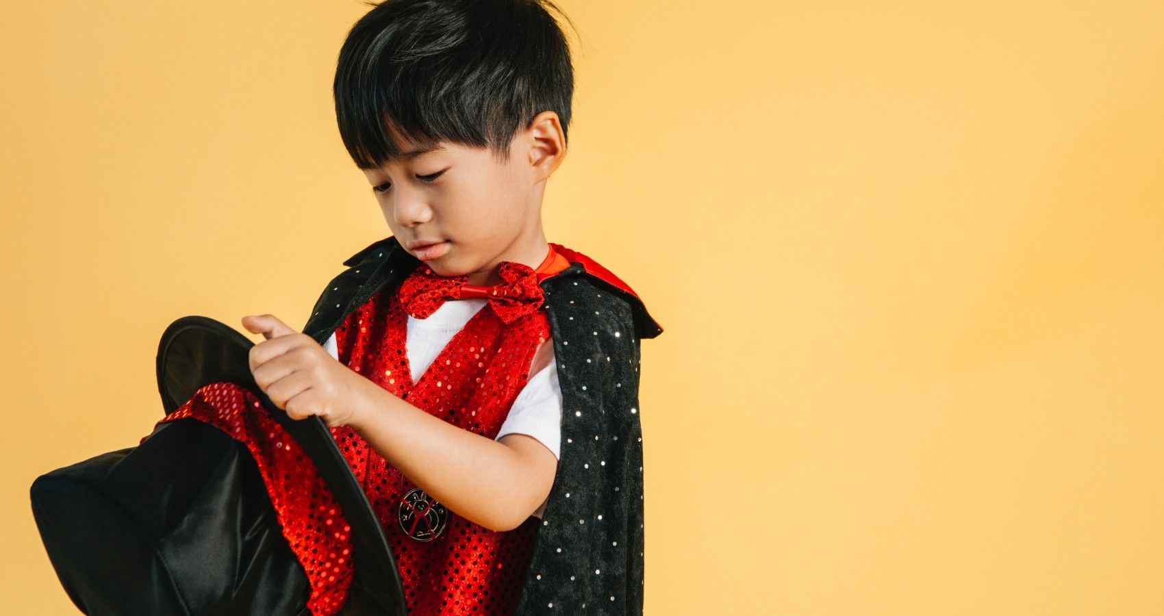 A Child With A Magician Outfit On Doing A Trick