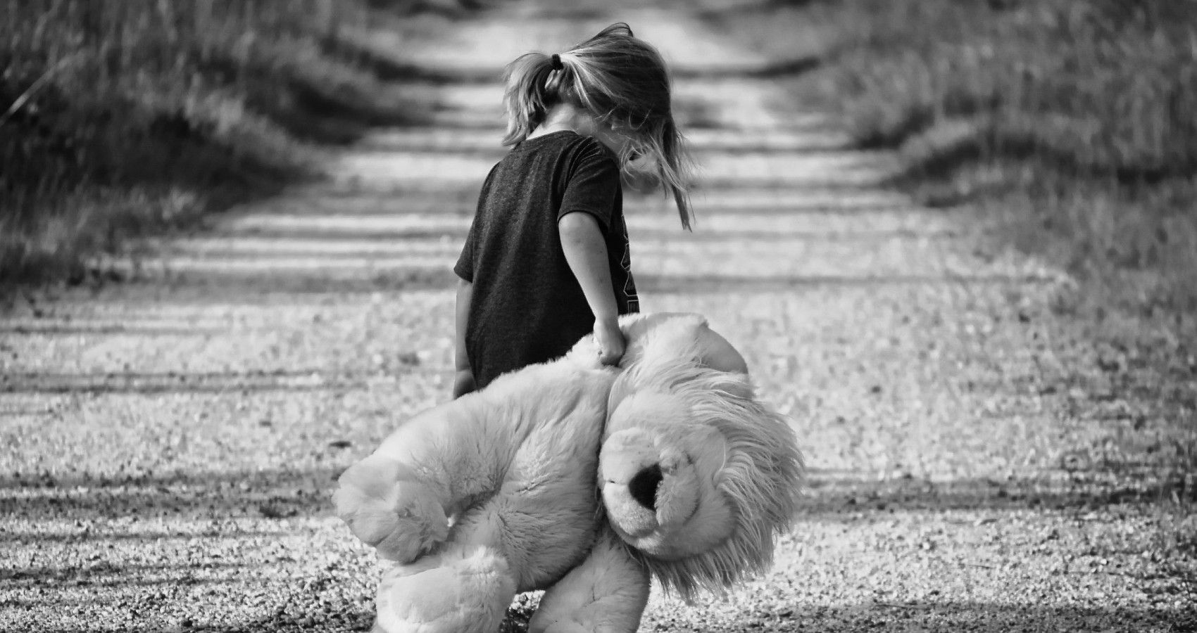 A Picture Of A Sad Child Holdin A Lion Black And White