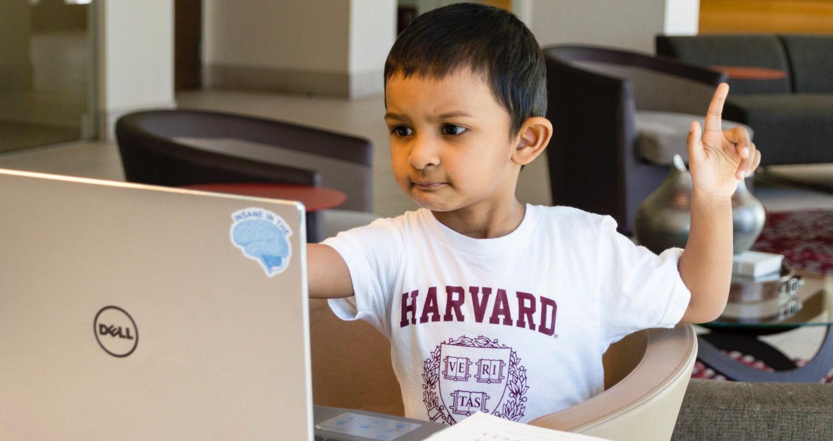 A Young Boy Using A Computer