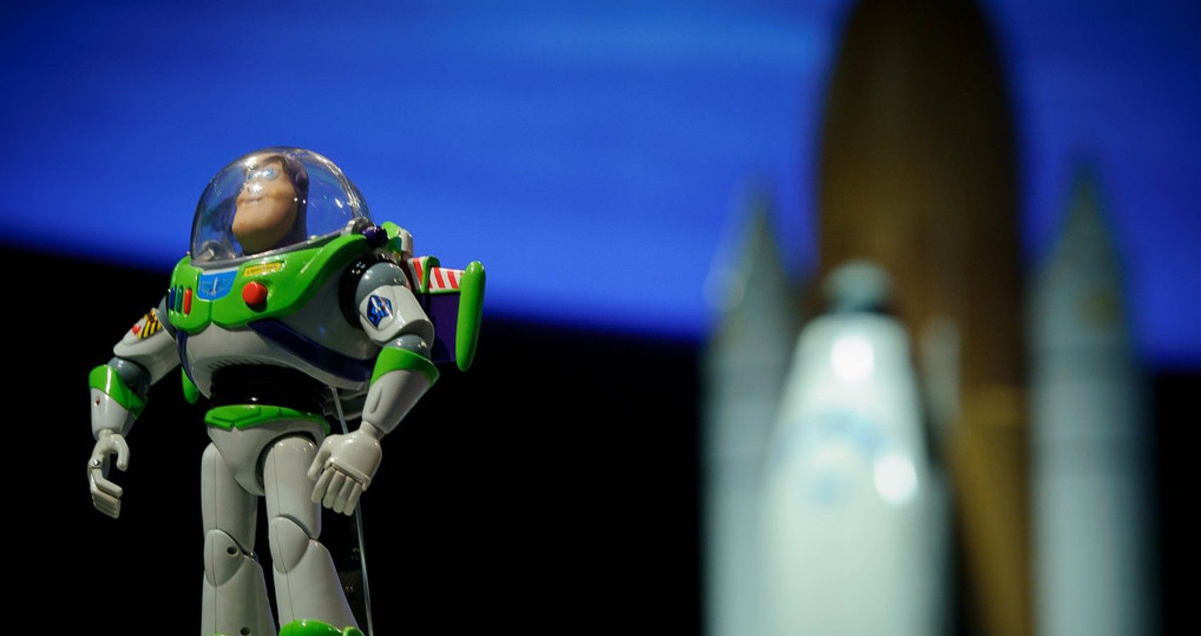 A Buzz Lightyear Doll Next To A Rocket Ship