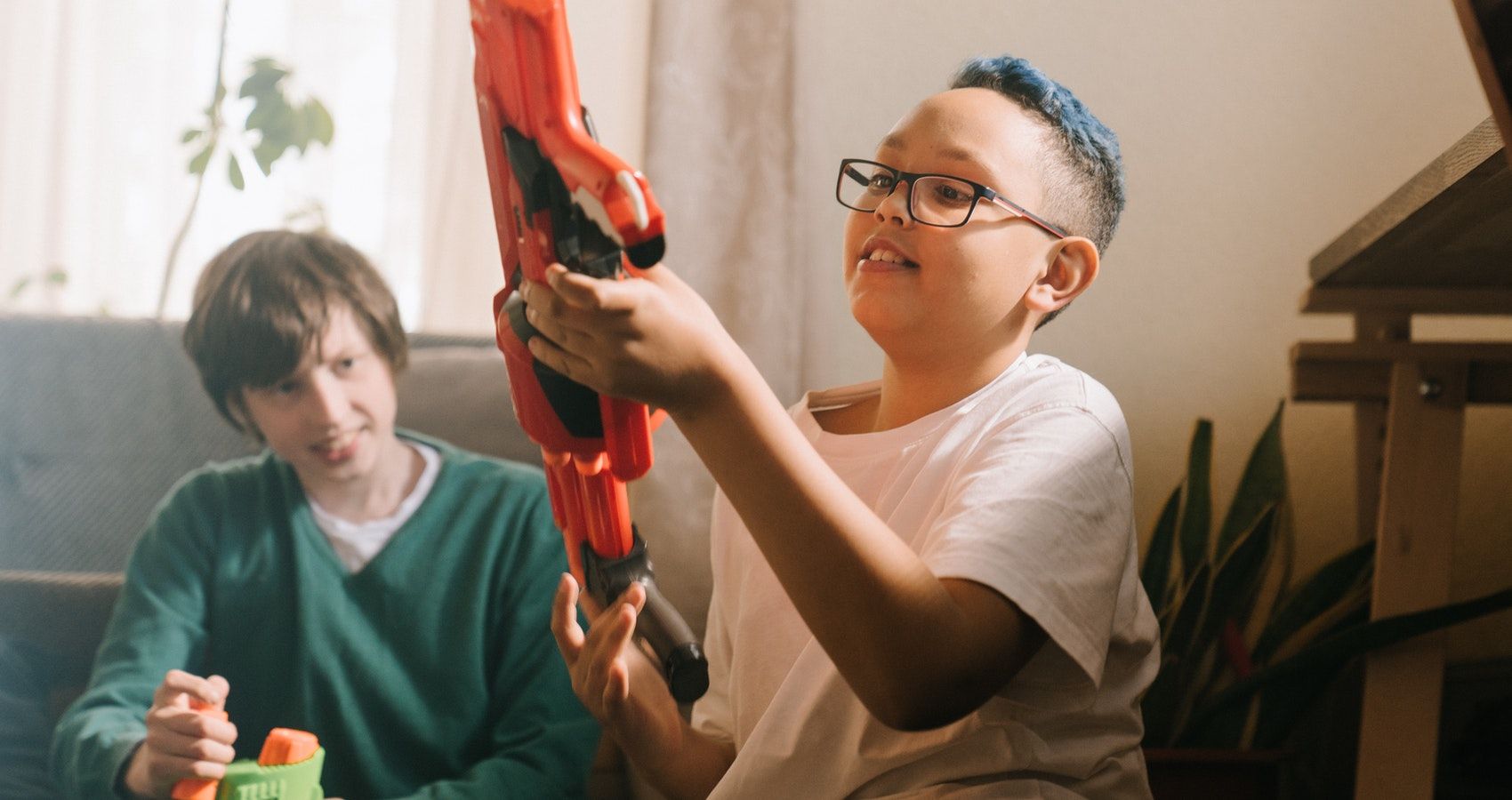 boy with a toy gun and friend