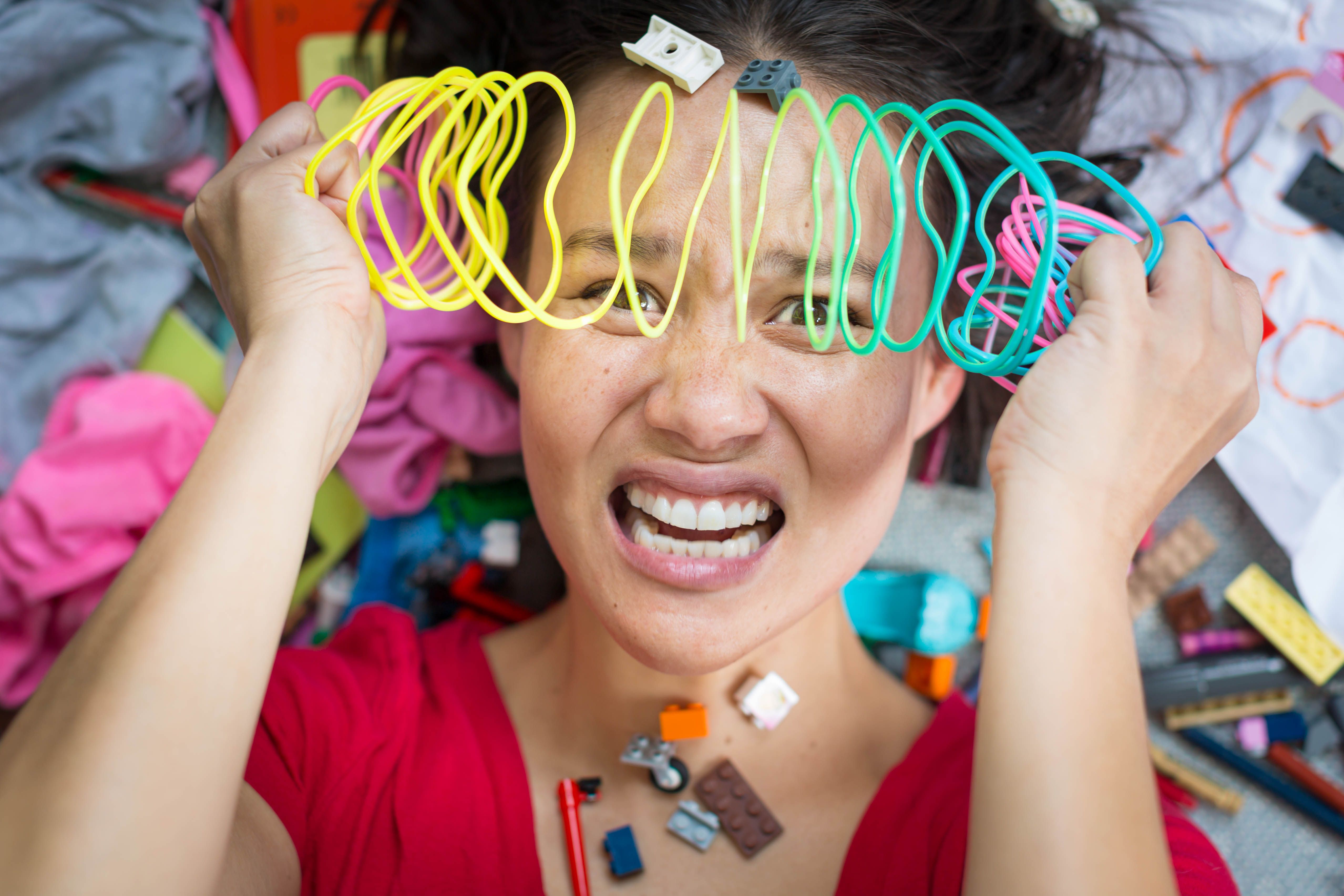 woman overwhelmed with toys on face
