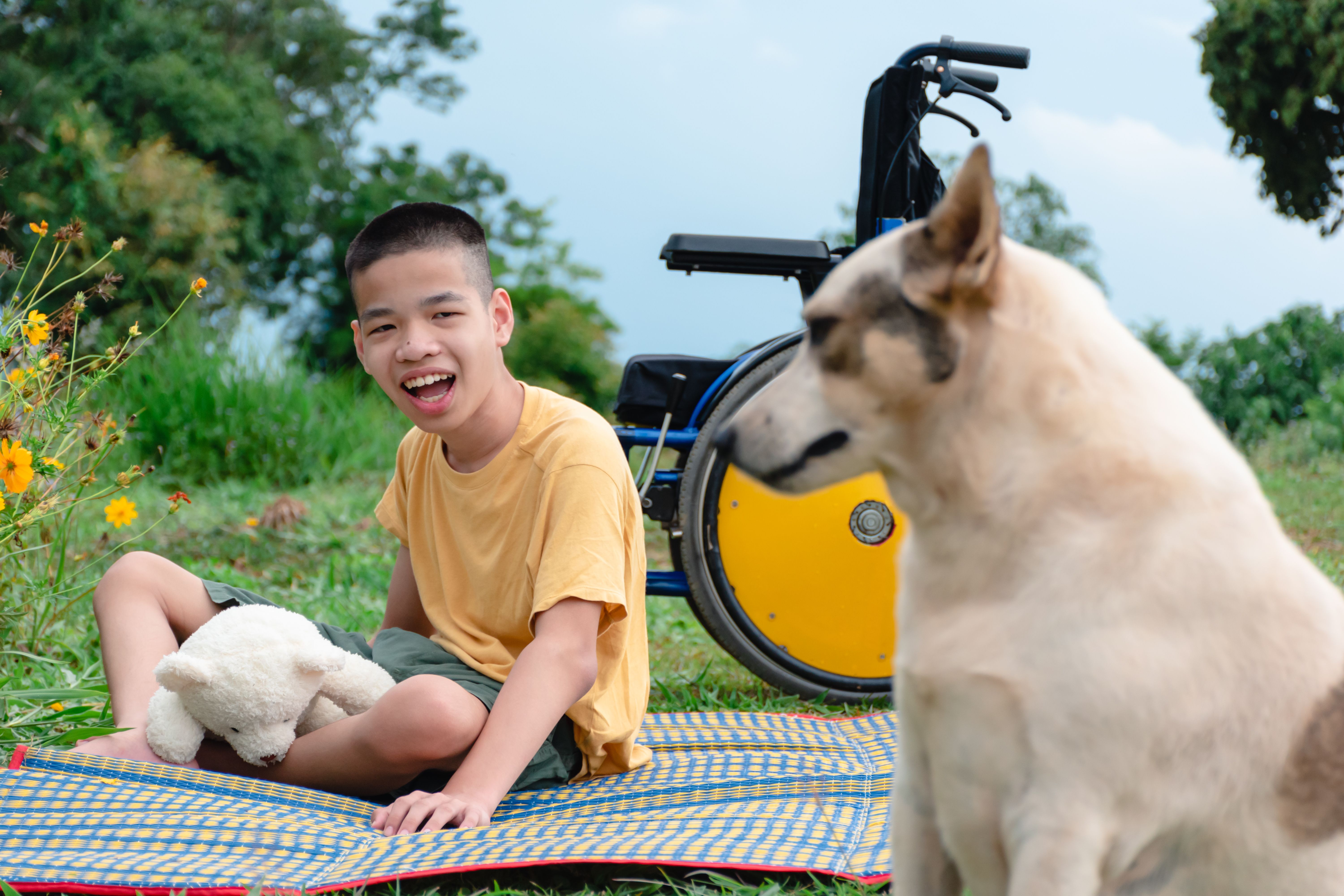 special needs boy at park with dog