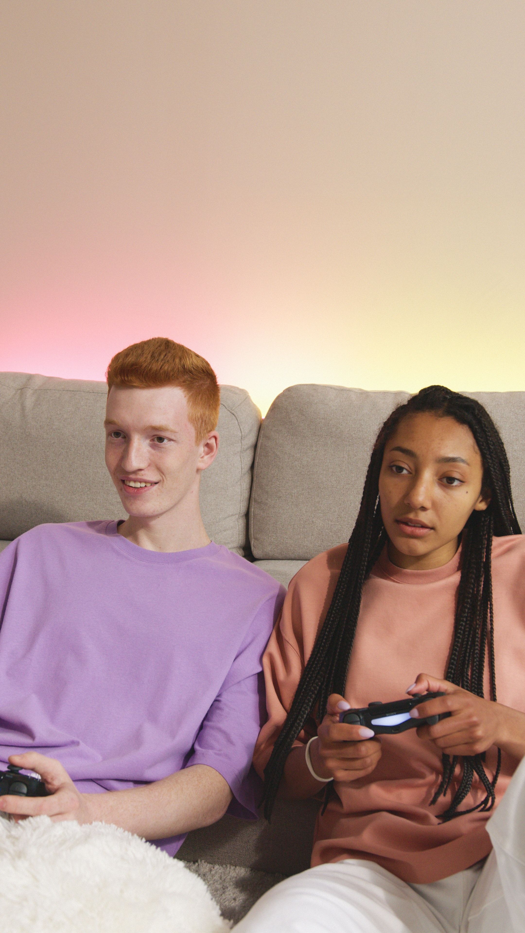 Two teenagers playing video games