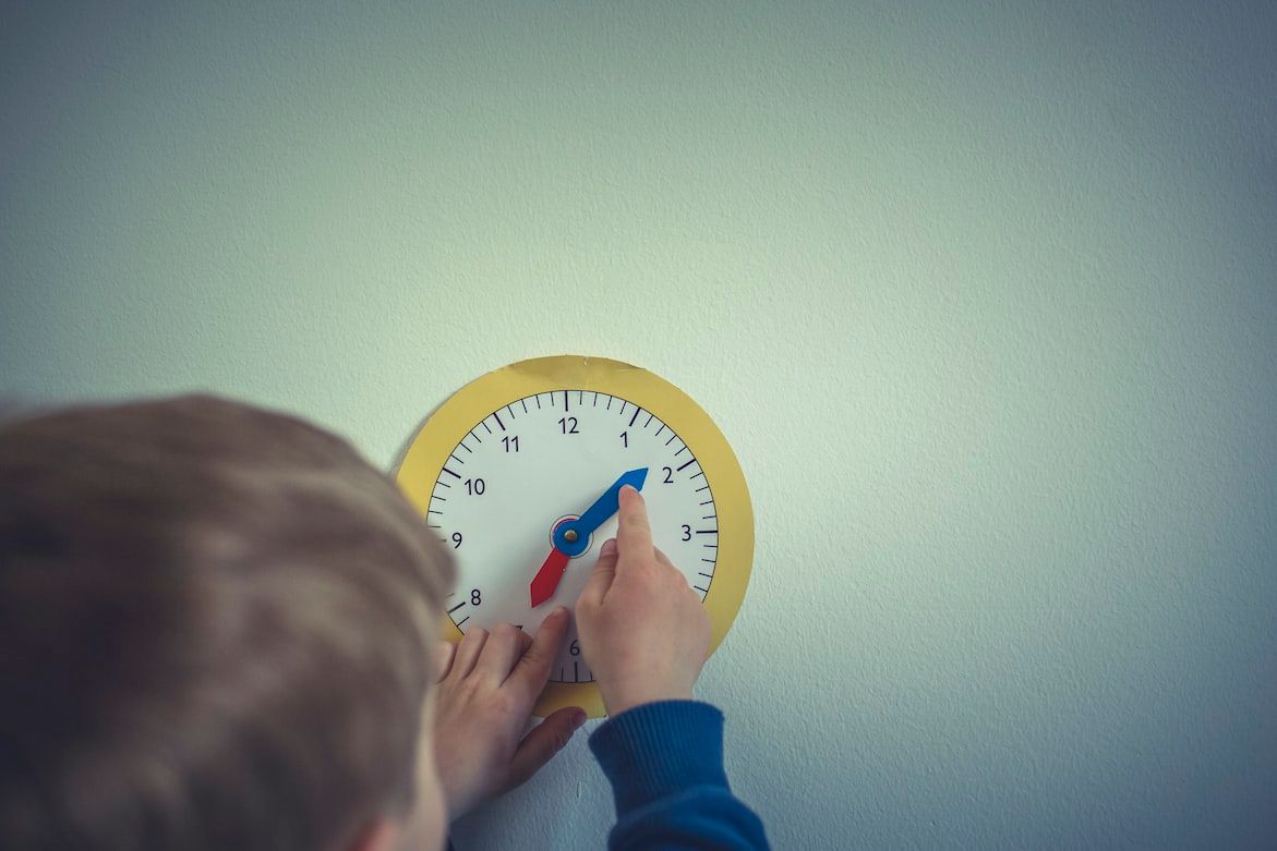 Young child using clock toy