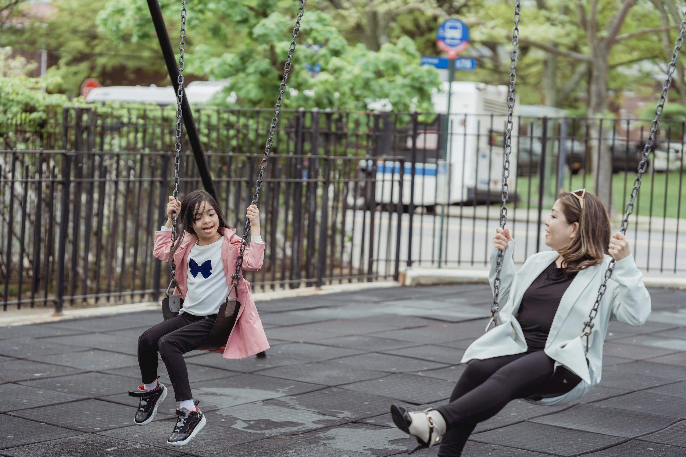 Mother and daughter on swings