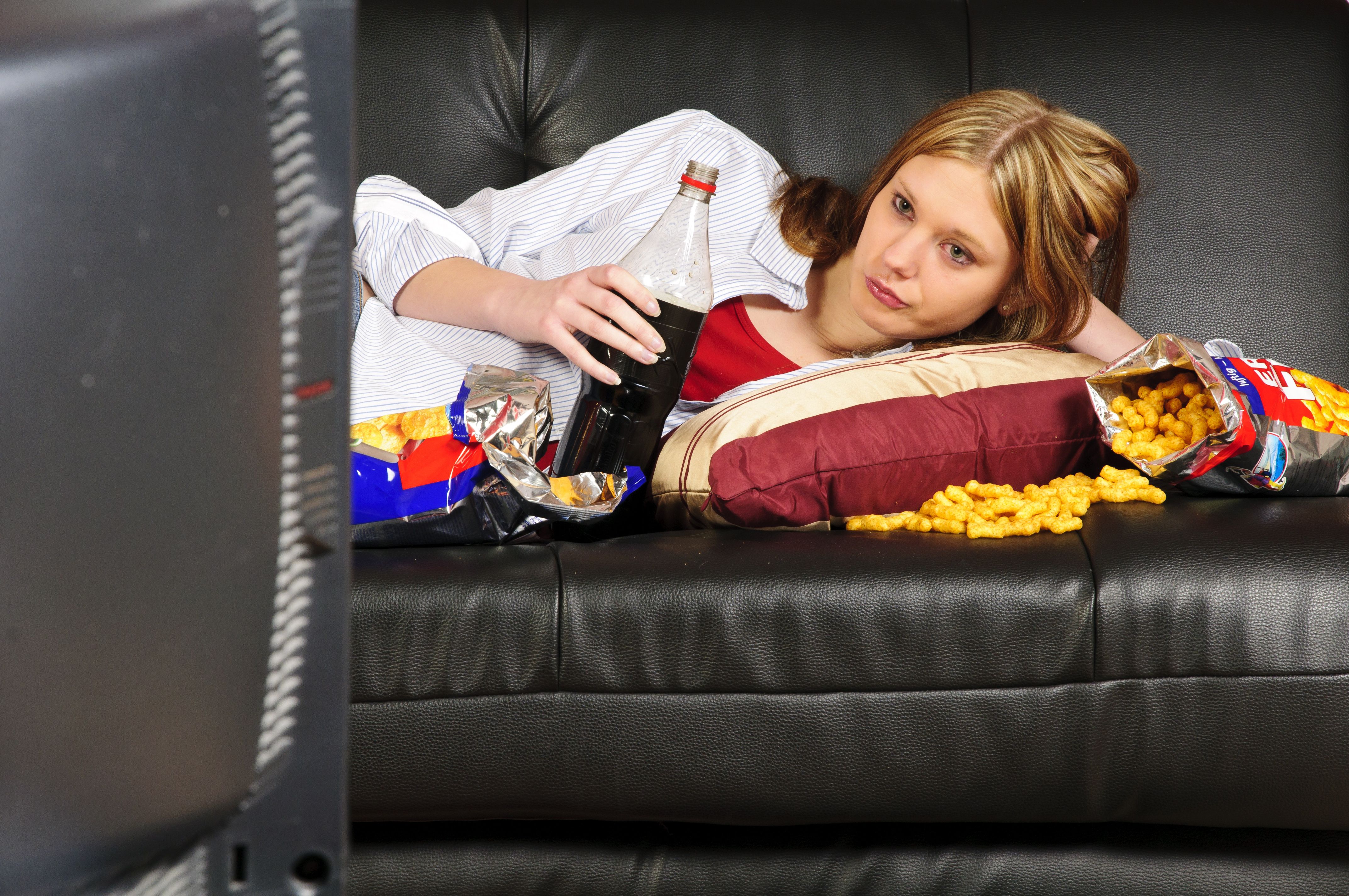 teen girl on couch with junk food