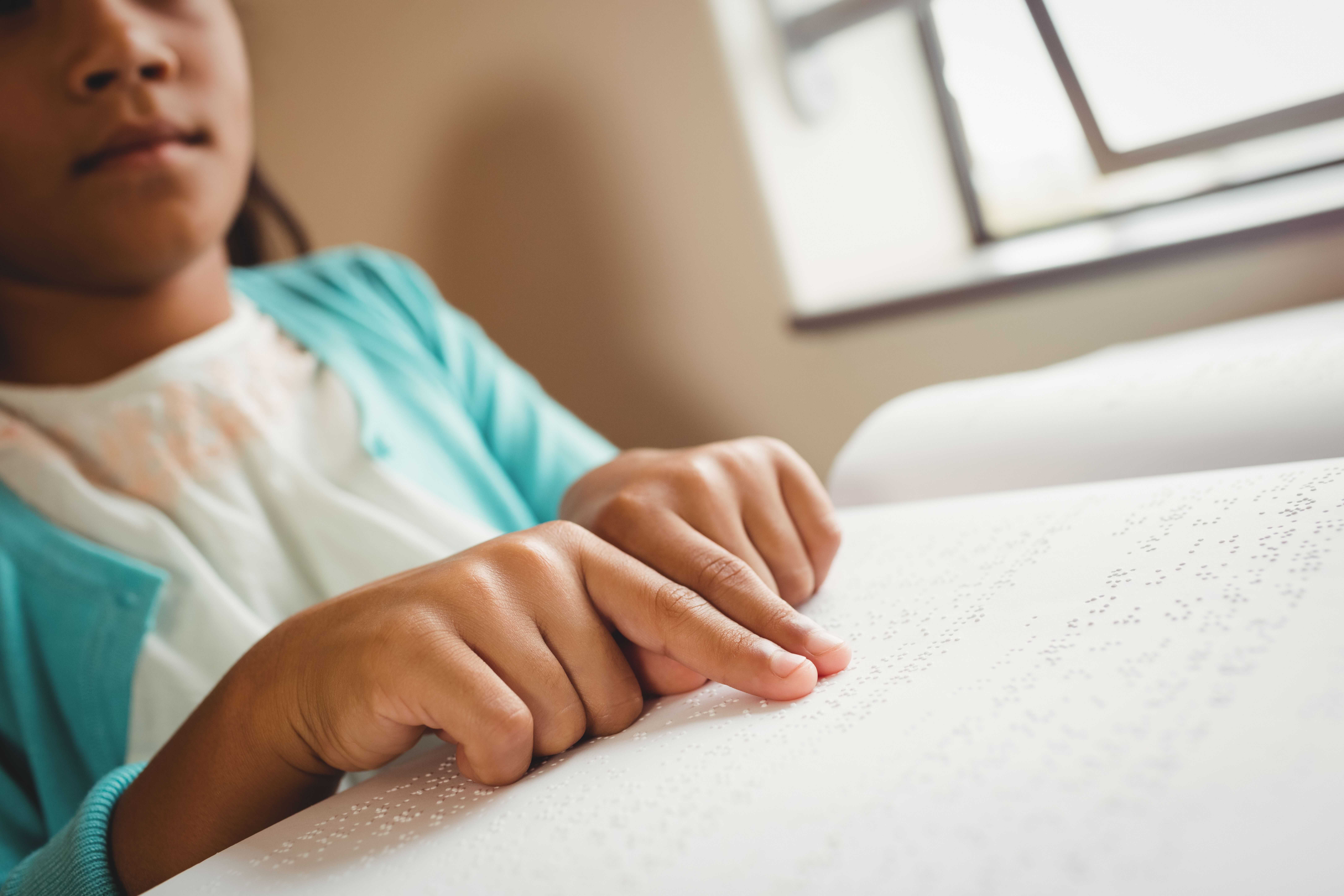 girl reading braille