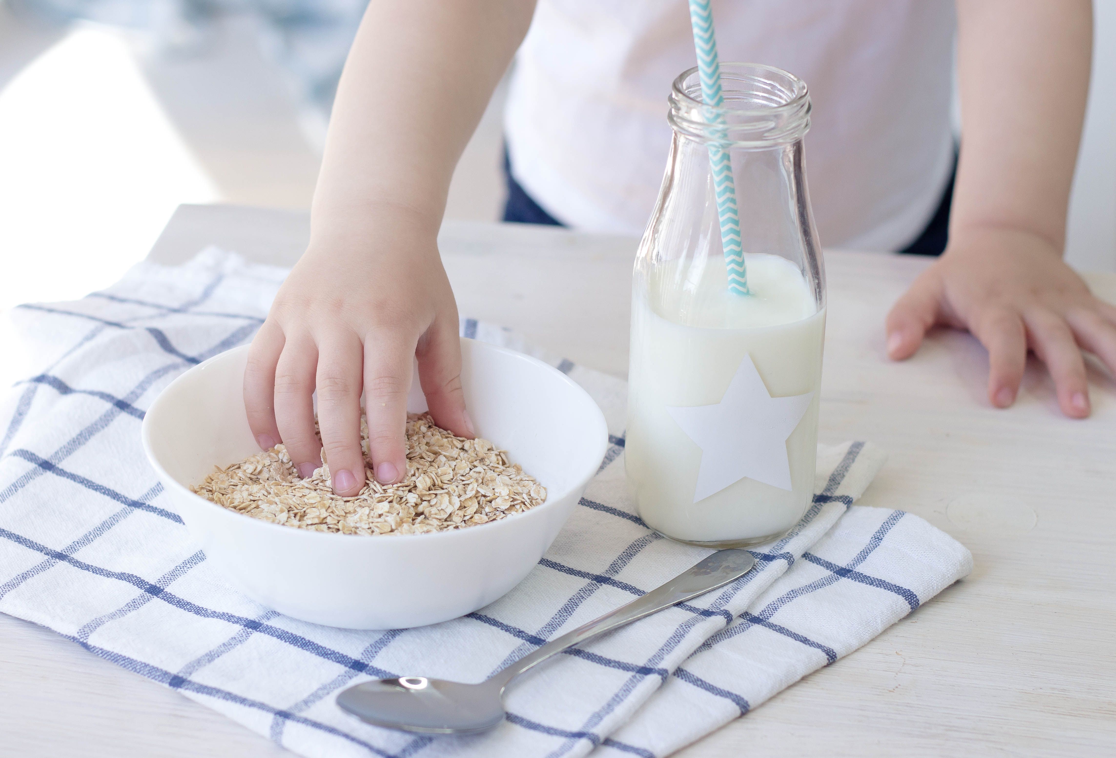 toddler hand in oatmeal