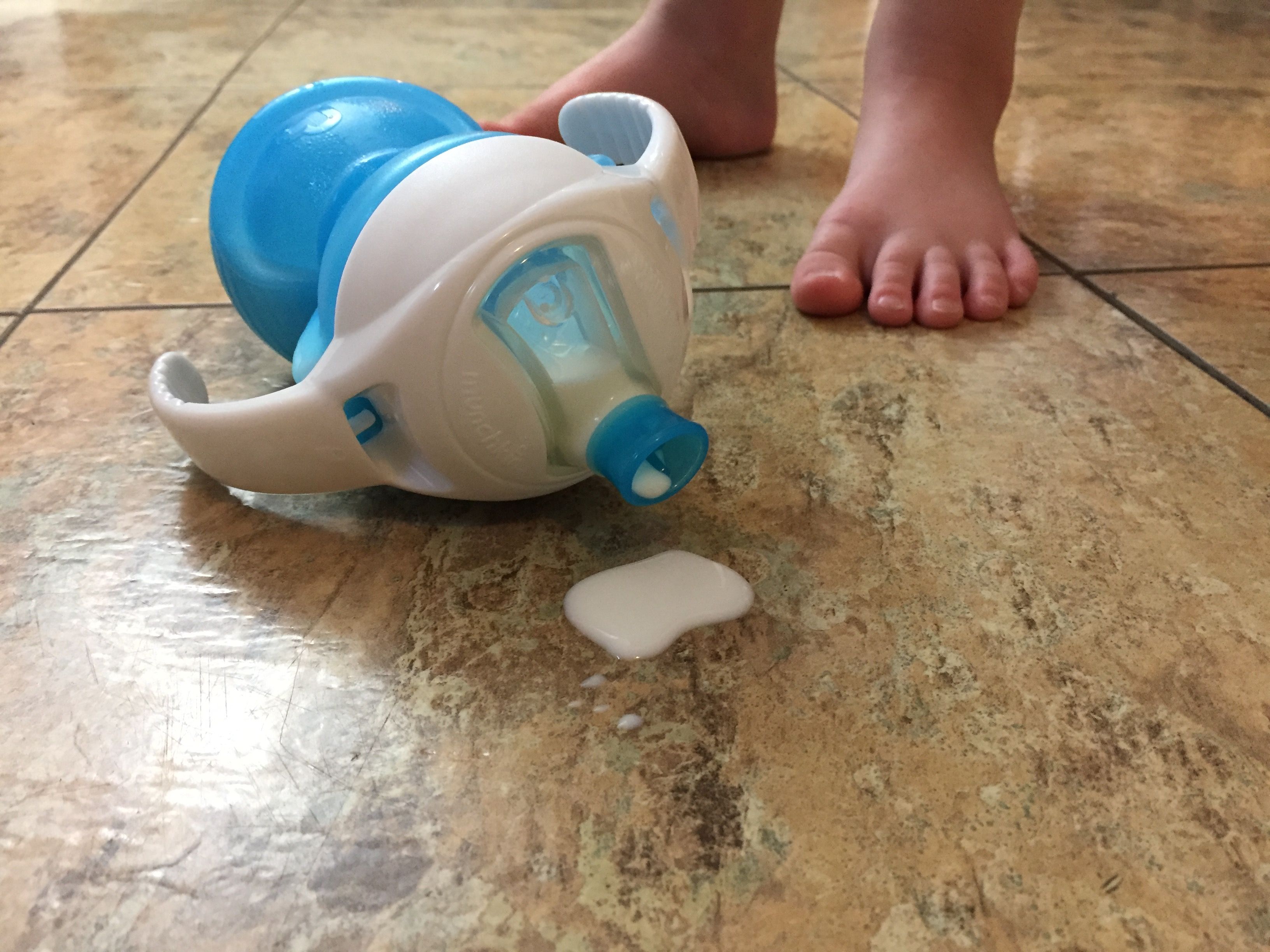 sippy cup on floor dripping milk
