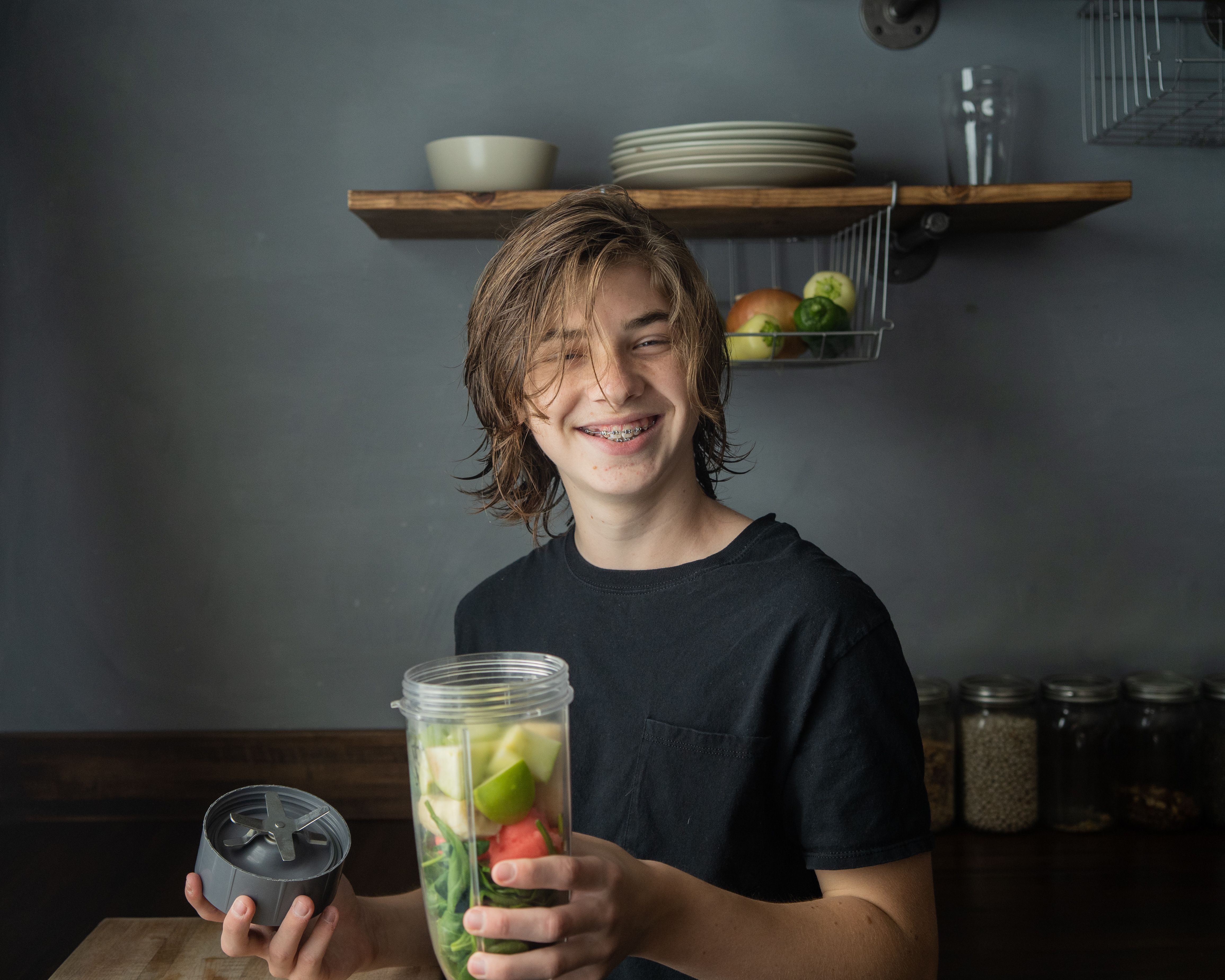 teen boy making smoothie