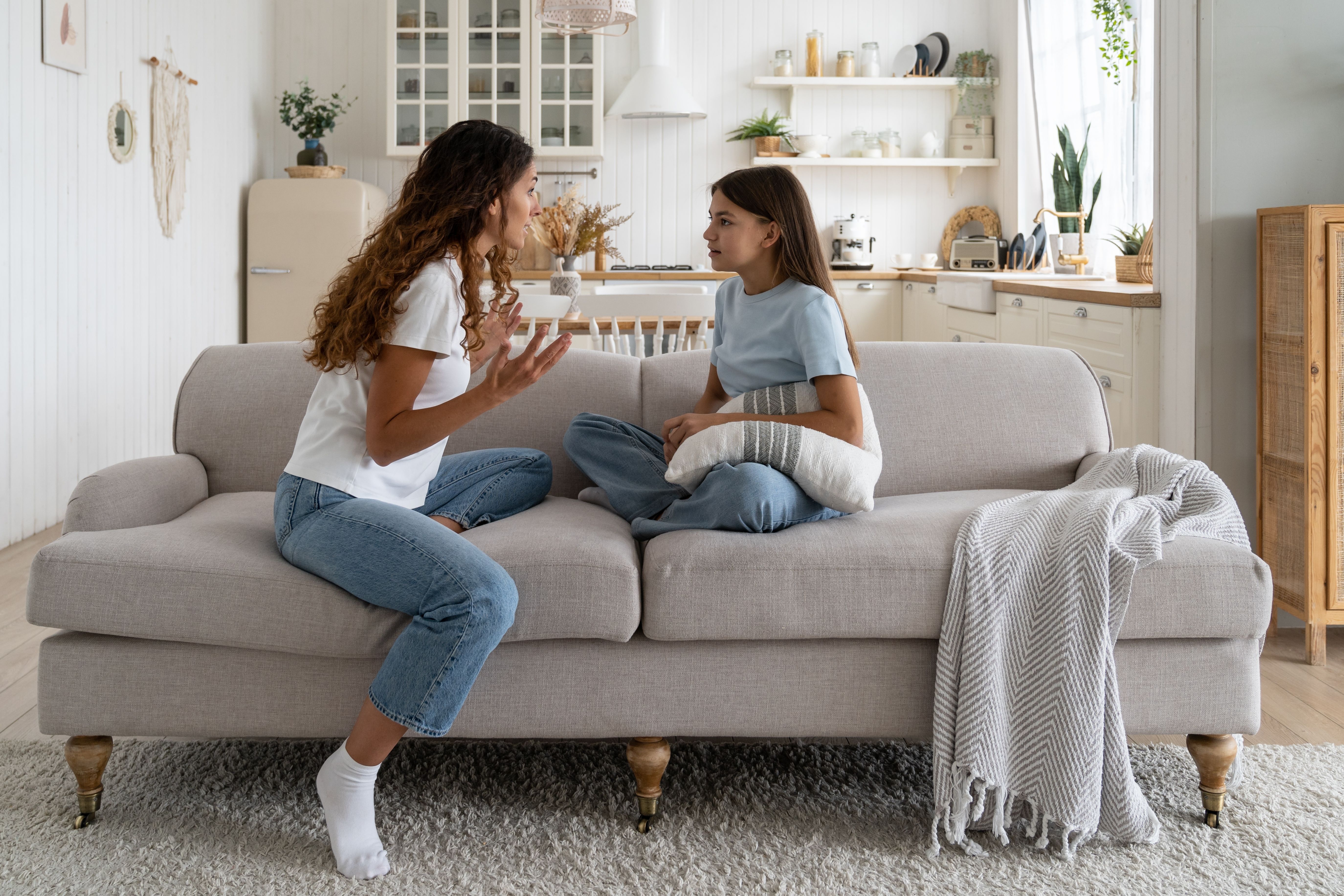 mom daughter talking on couch