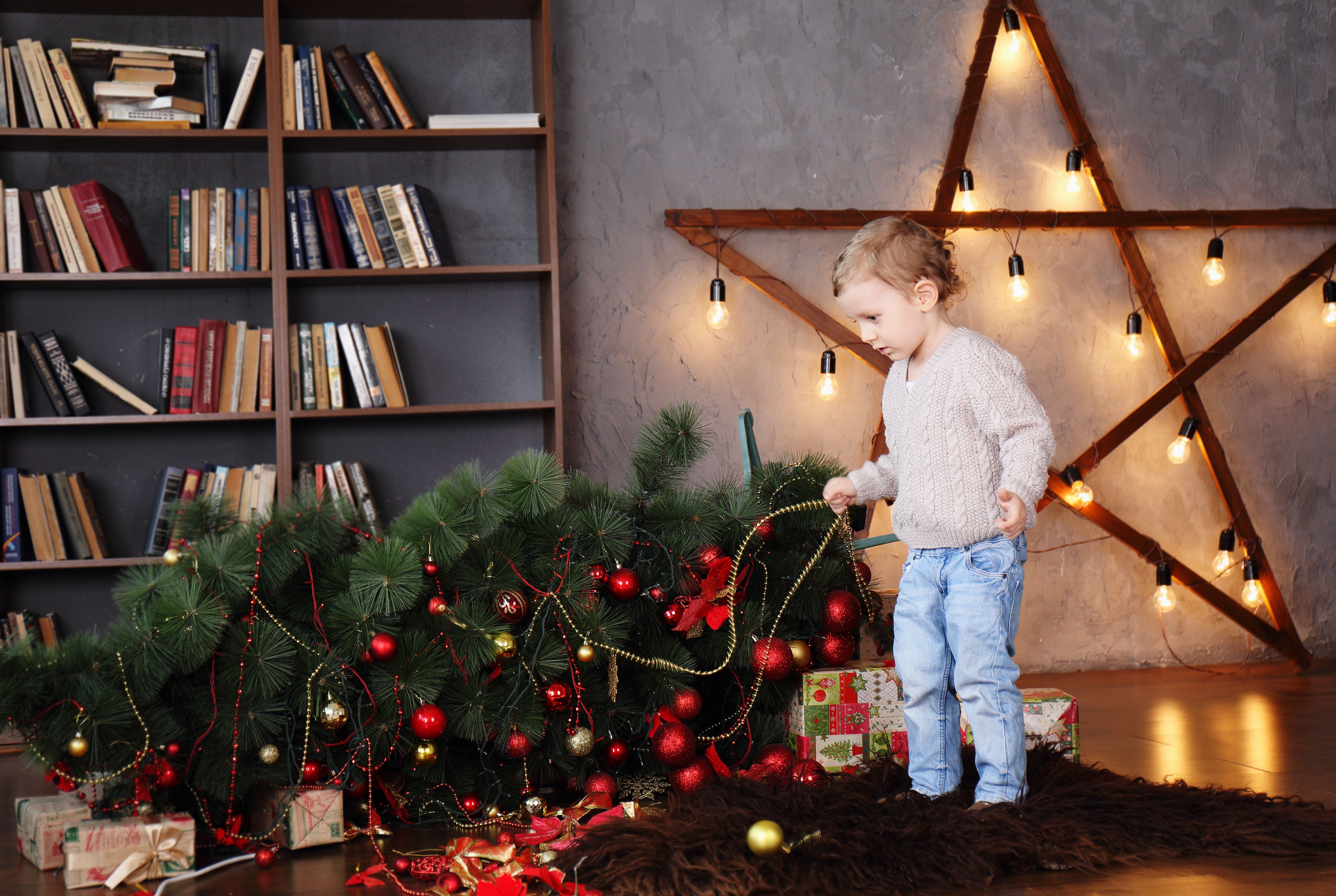 Christmas tree on floor with toddler