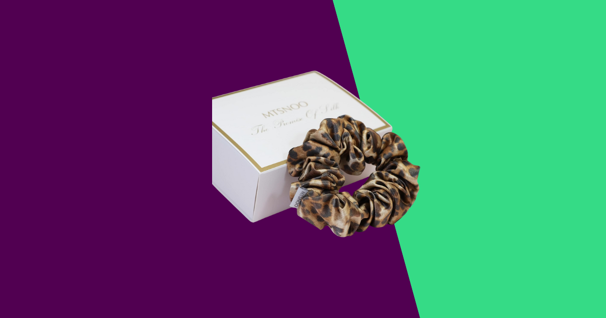 purple and green background with leopard scruchie and white box