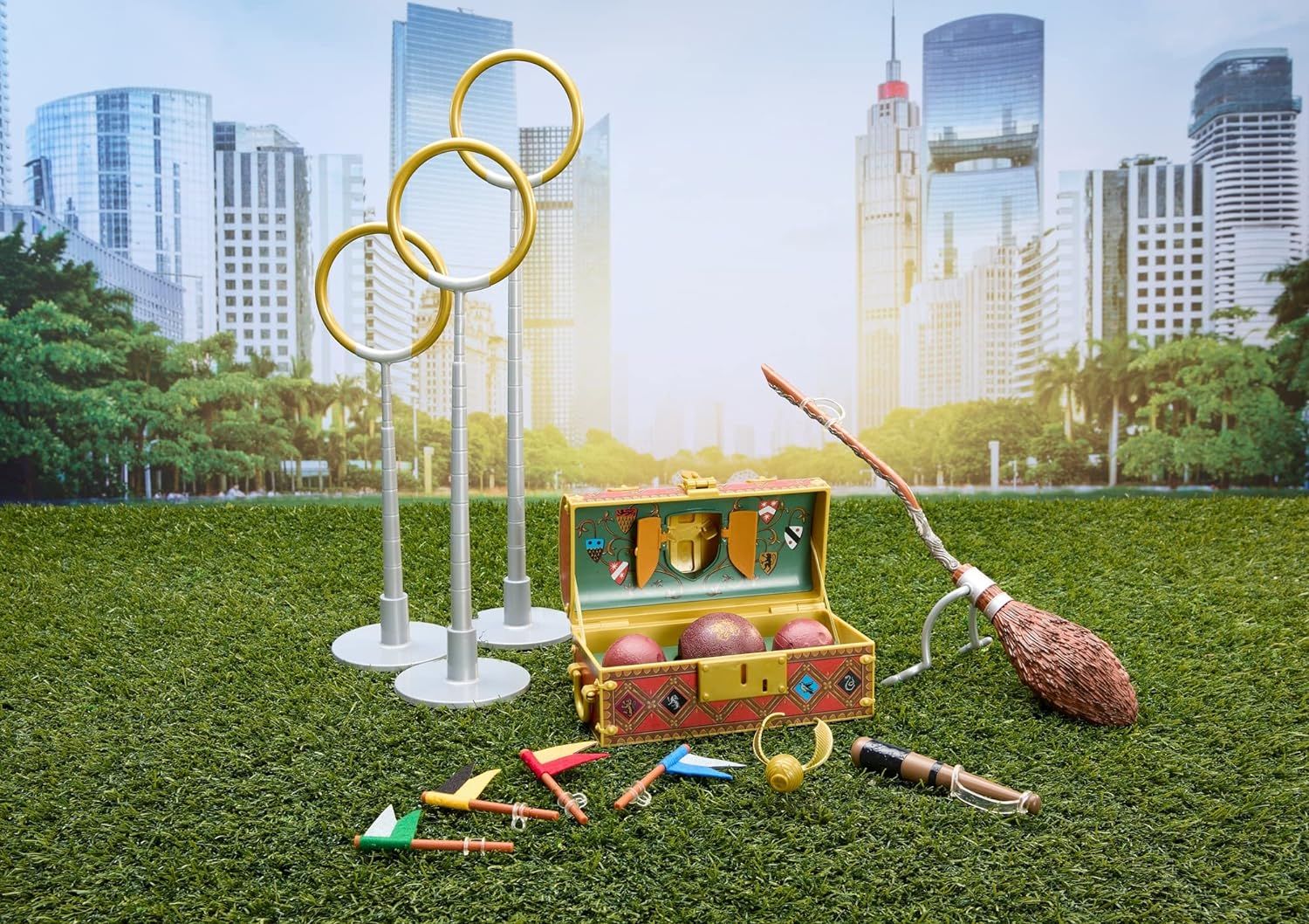 American Girl Doll Harry Potter accessories for Quidditch on a field with a city scape in the background