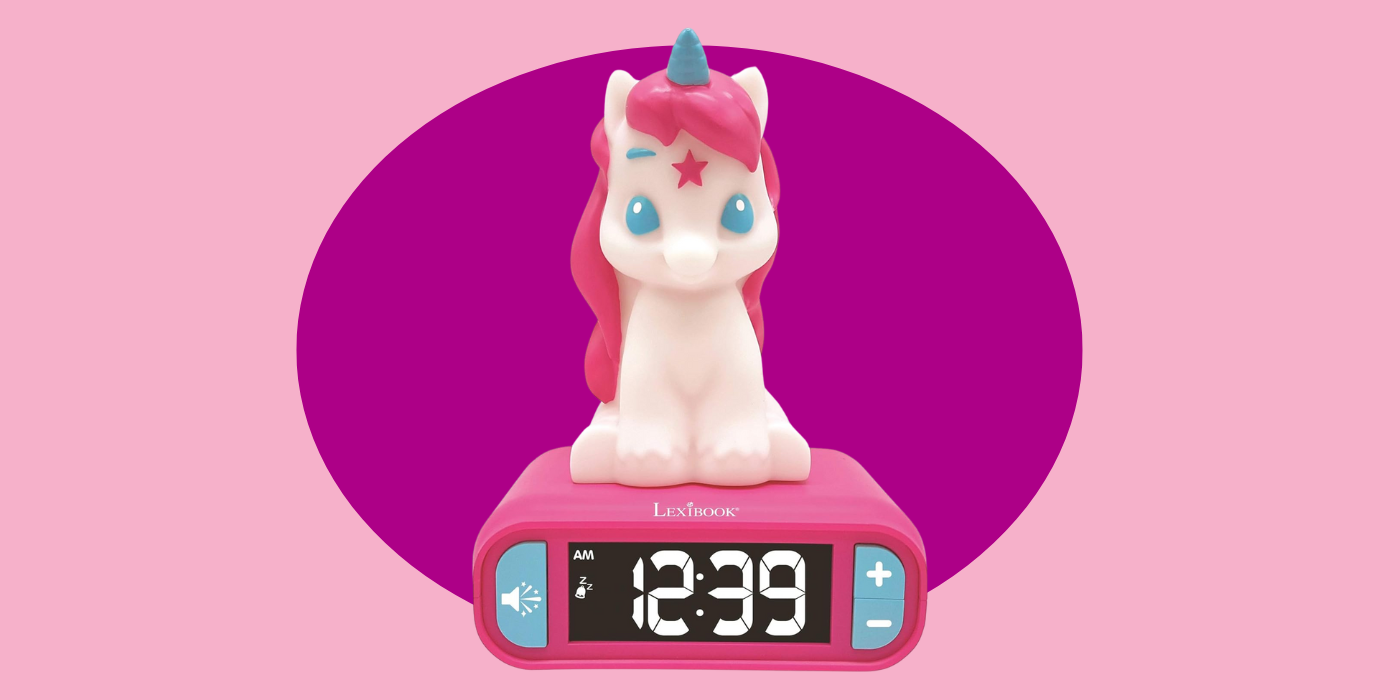 pink background with an alarm clock that has a unicorn